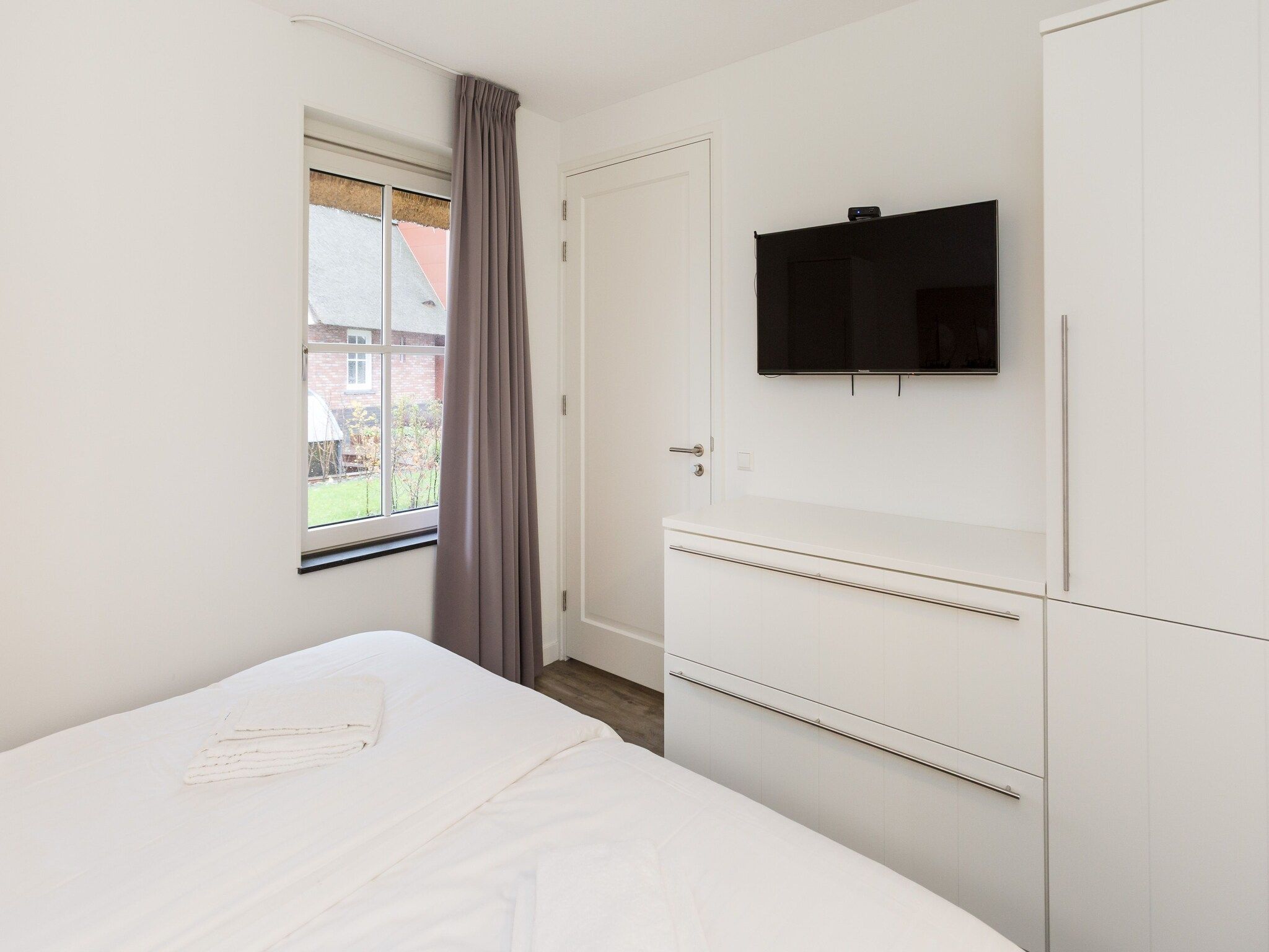 Een slaapkamer van Friese Meren Villa's 17 in Delfstrahuizen