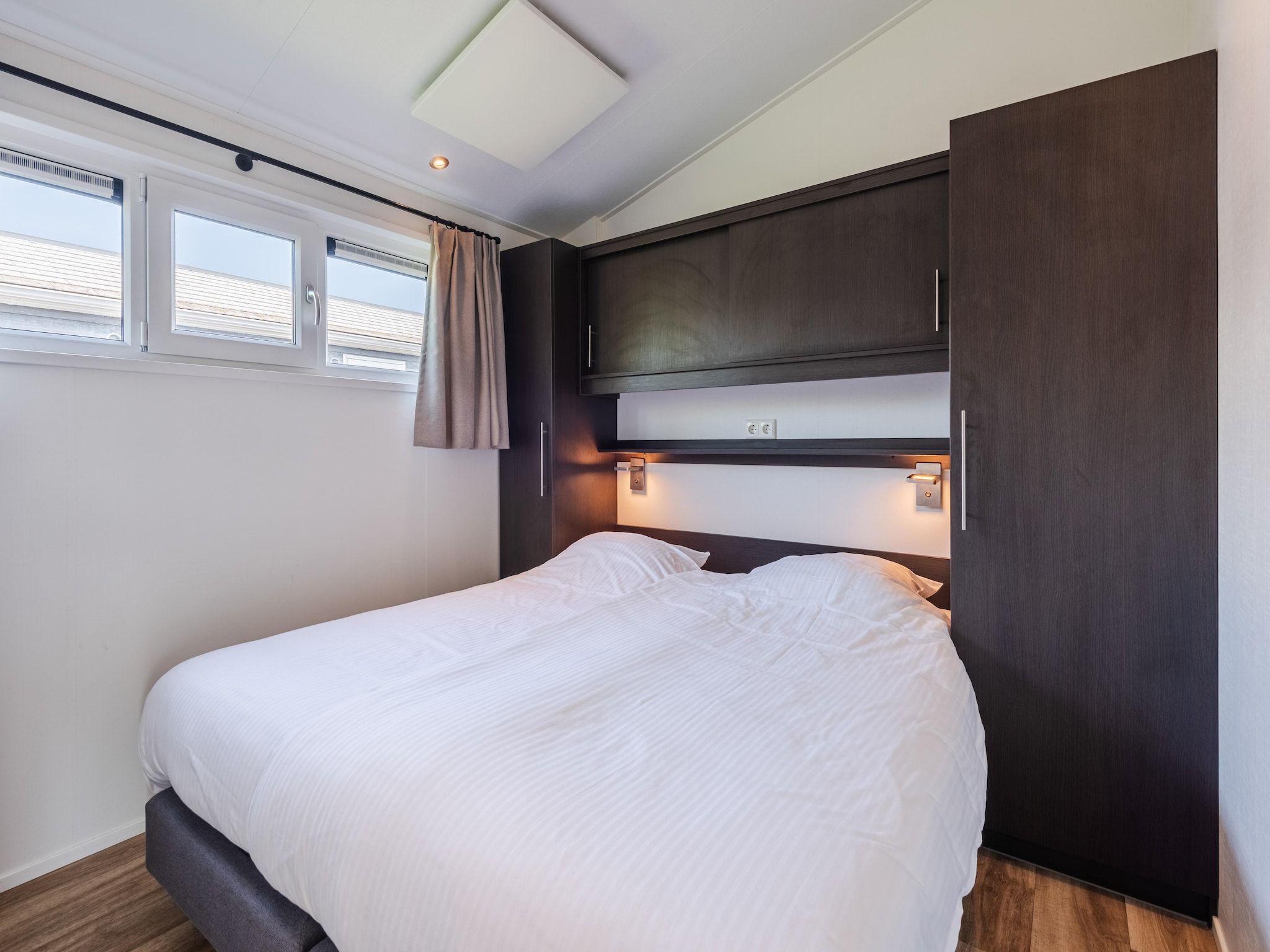 Een slaapkamer van Vakantiepark Giethoorn 10 in Giethoorn