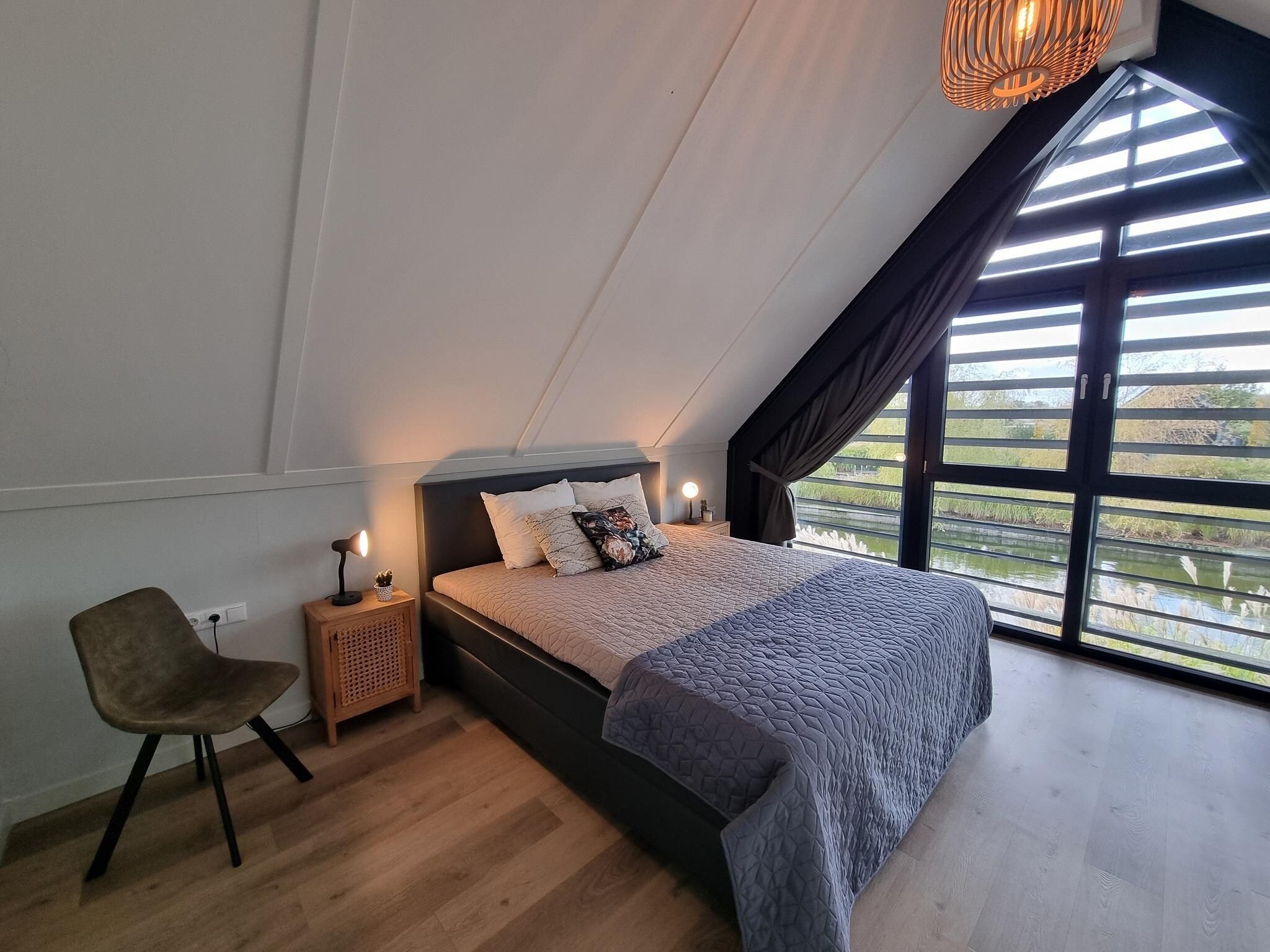Een slaapkamer van Watervilla Twa in Balk