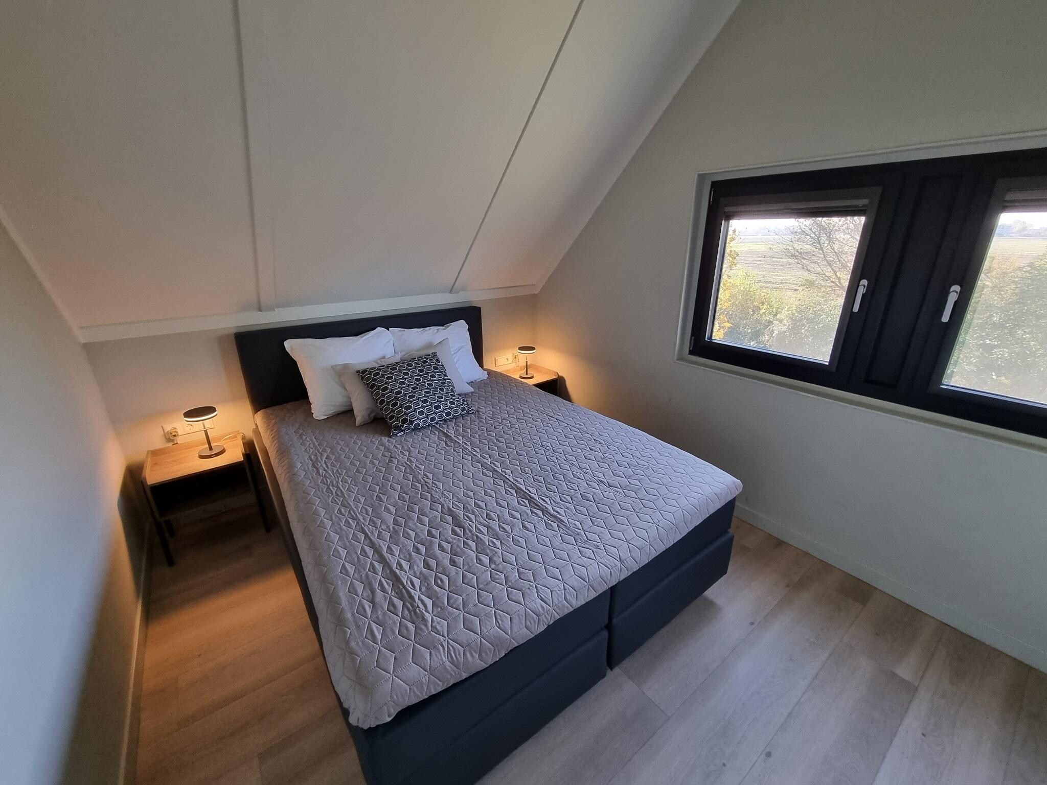 Een slaapkamer van Watervilla Twa in Balk
