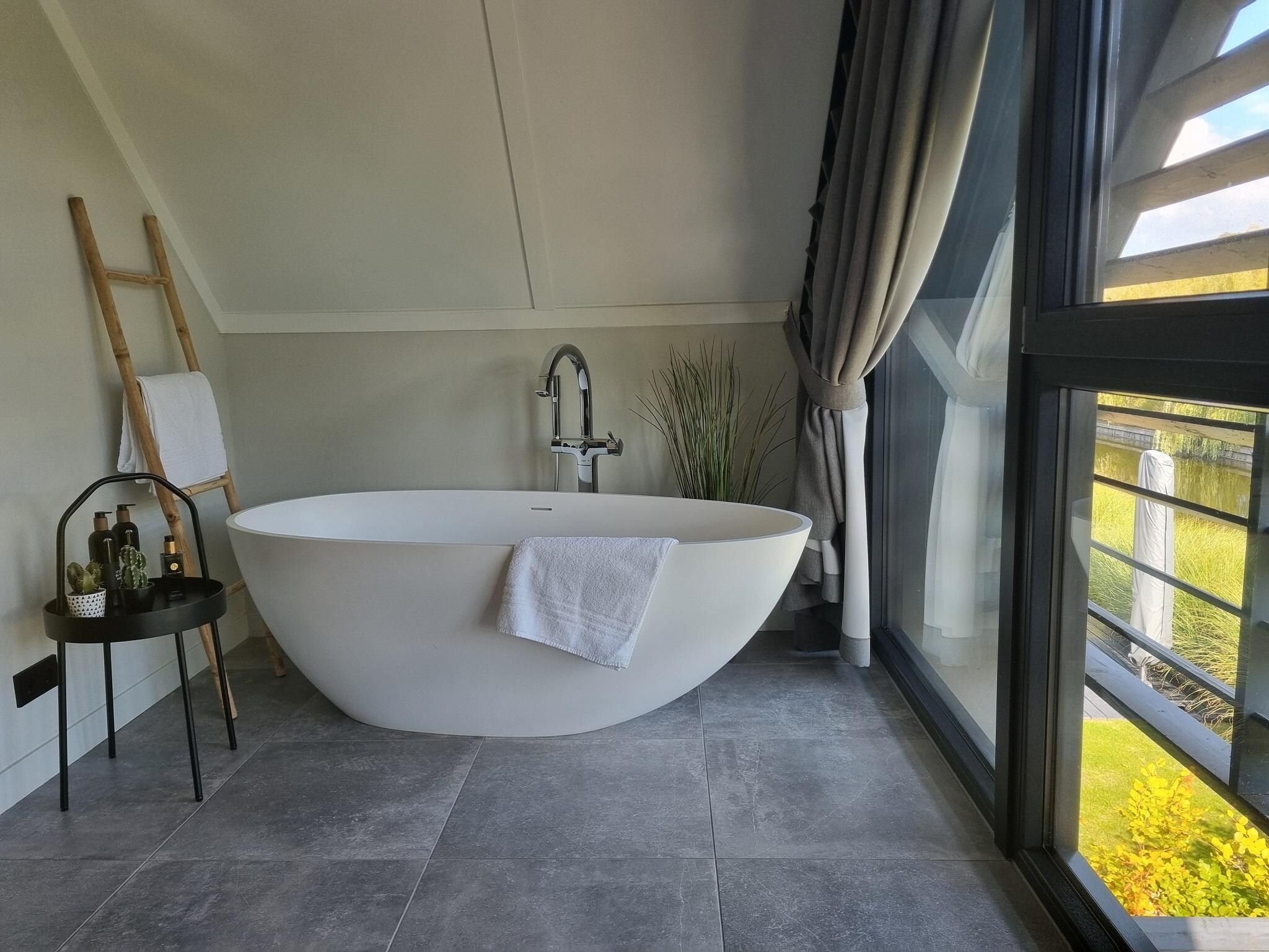 Een slaapkamer van Watervilla Tsien in Balk