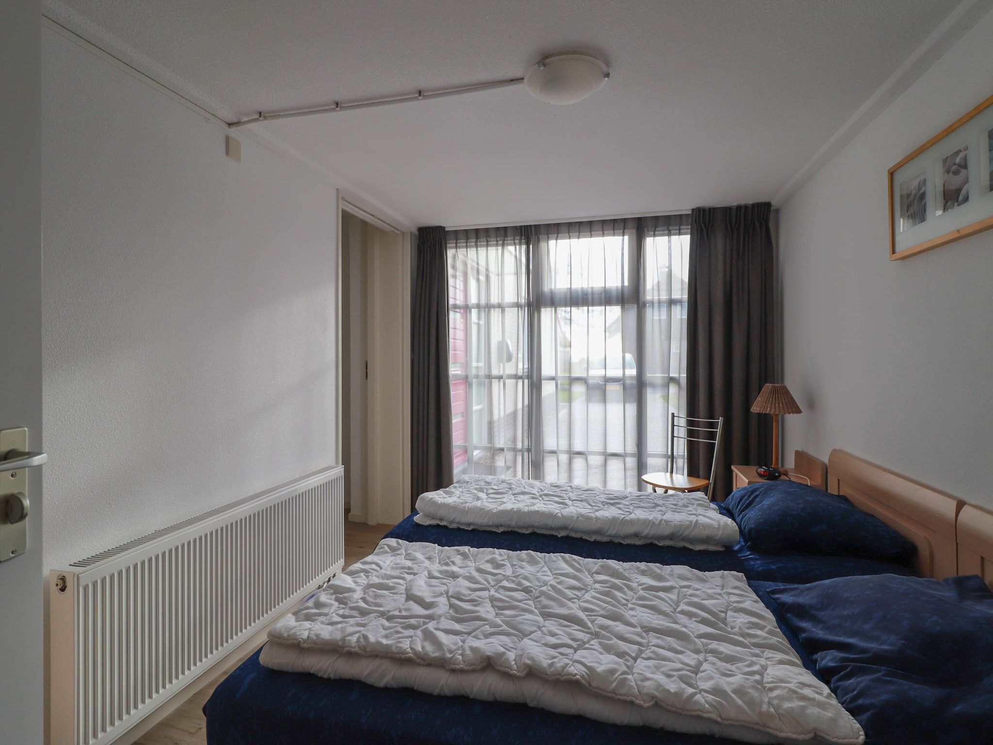 Een slaapkamer van Duinvilla Deluxe met Sauna - 8 personen in Makkum
