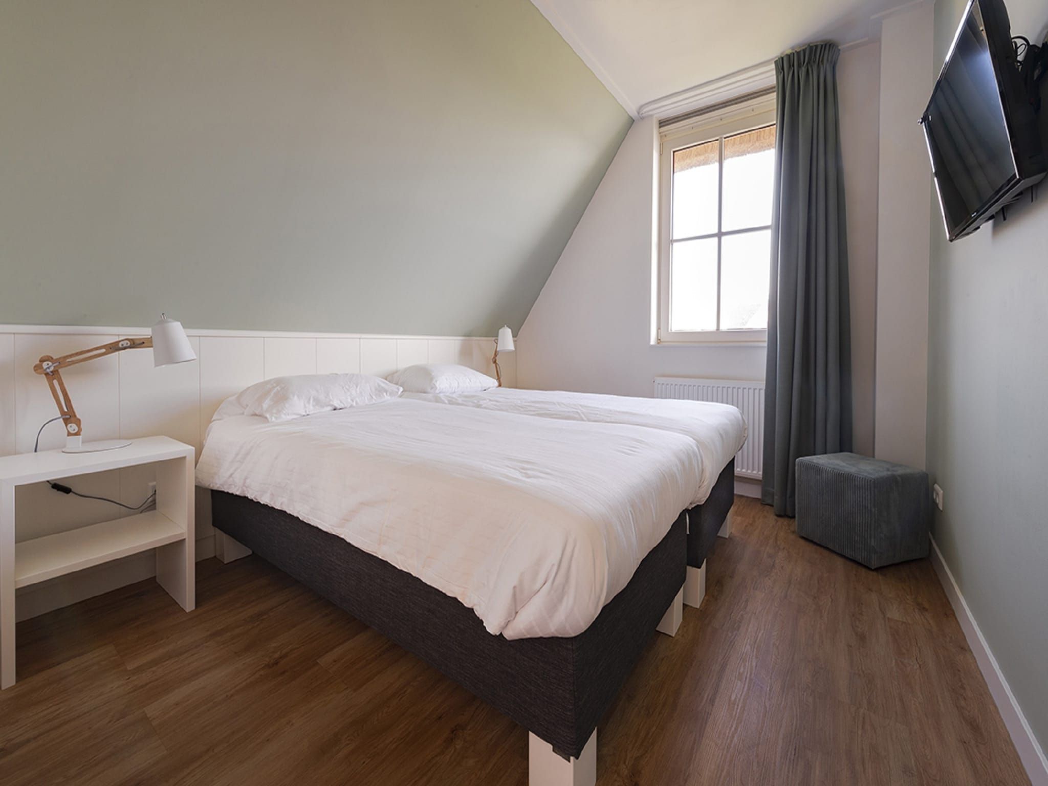 Een slaapkamer van Friese Meren Villa's 22 in Delfstrahuizen