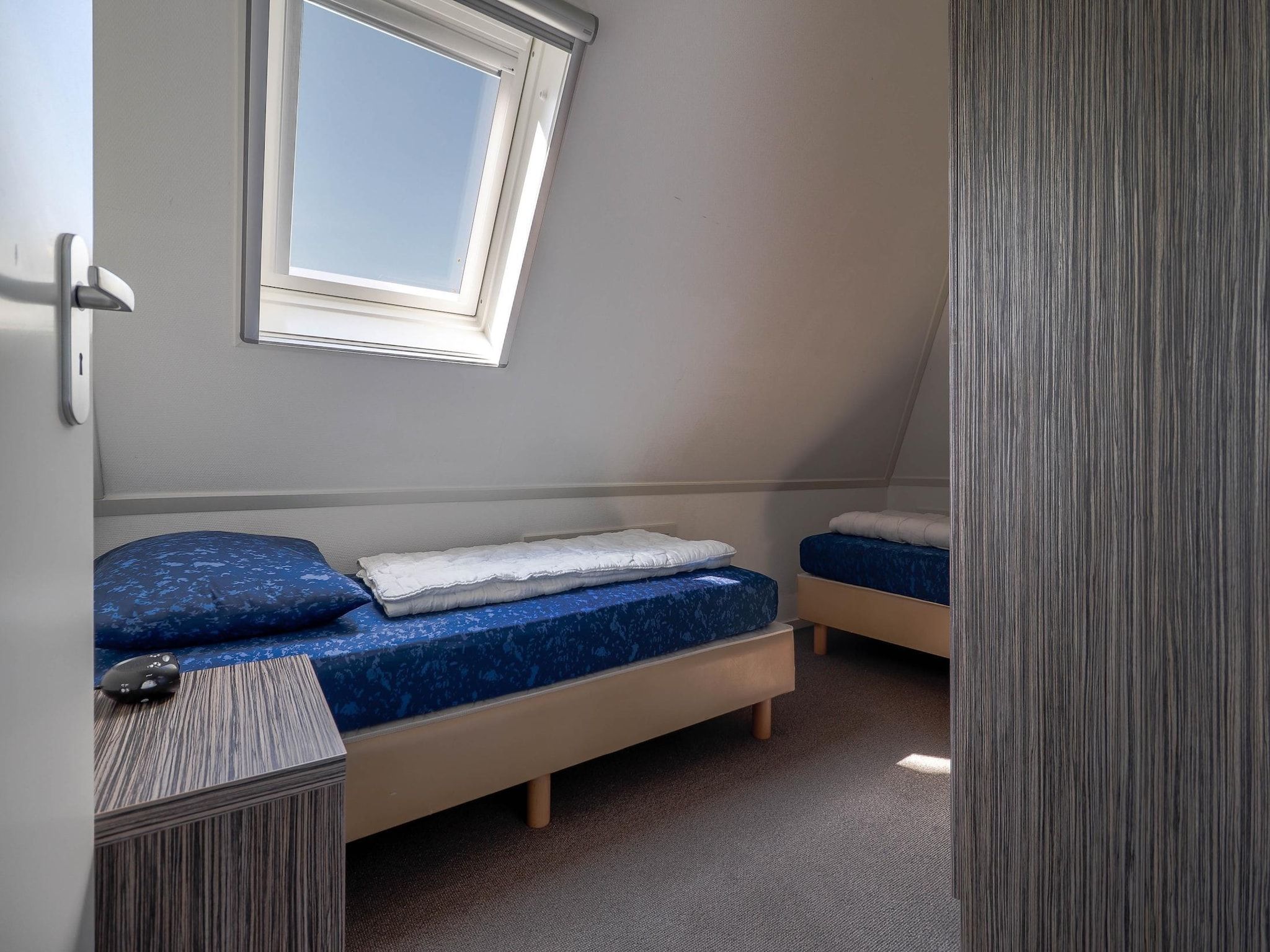Een slaapkamer van Beachvilla XL - 12 persons in Makkum
