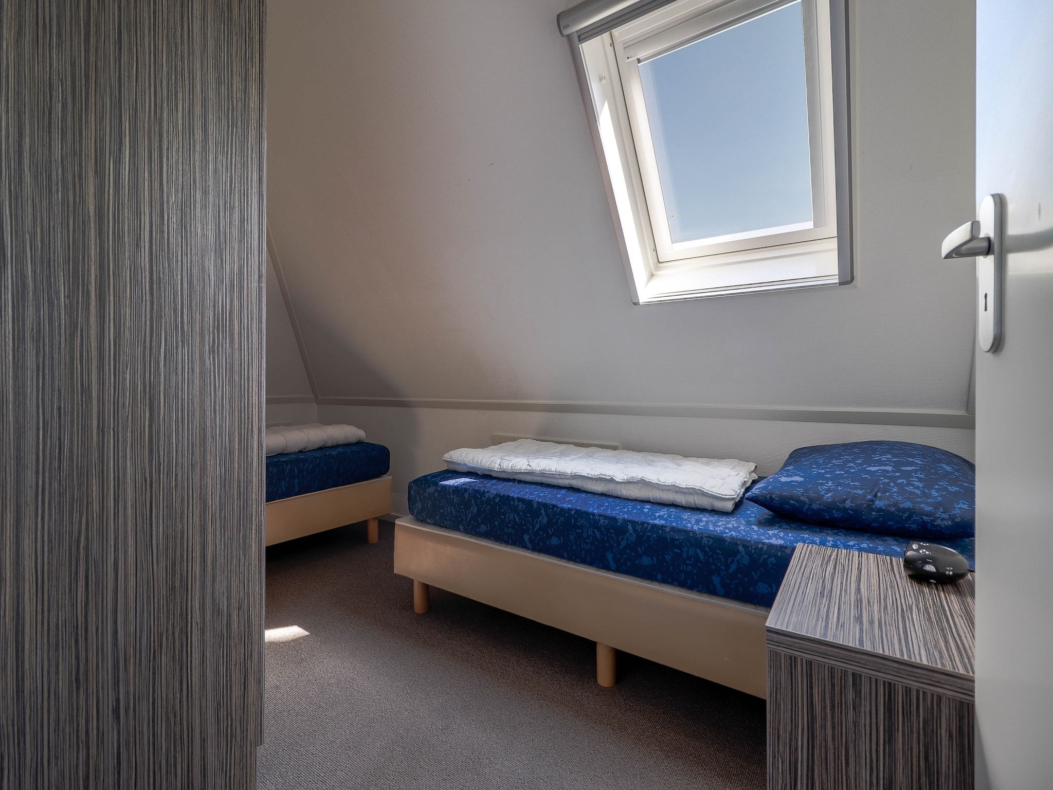 Een slaapkamer van Beachvilla XL - 12 persons in Makkum