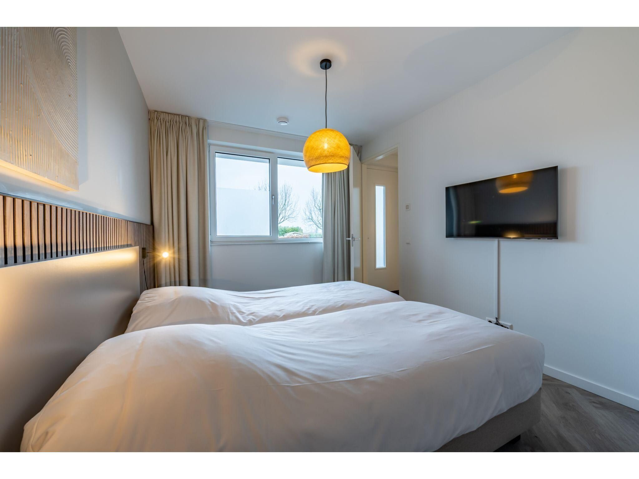 Een slaapkamer van Harbour Loft1J-havenzicht in Kamperland