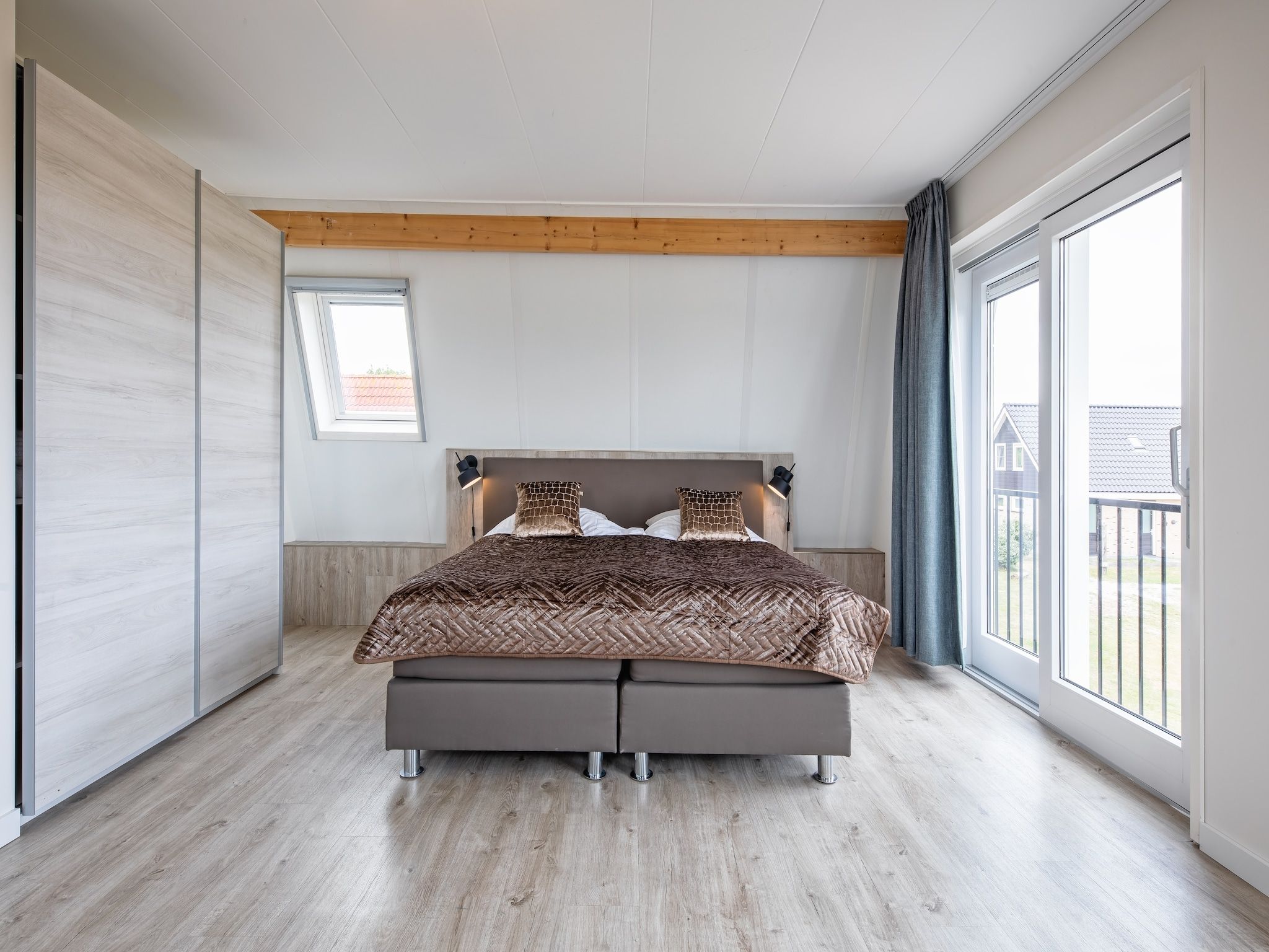 Een slaapkamer van Wulpenweid 10 in Den Burg