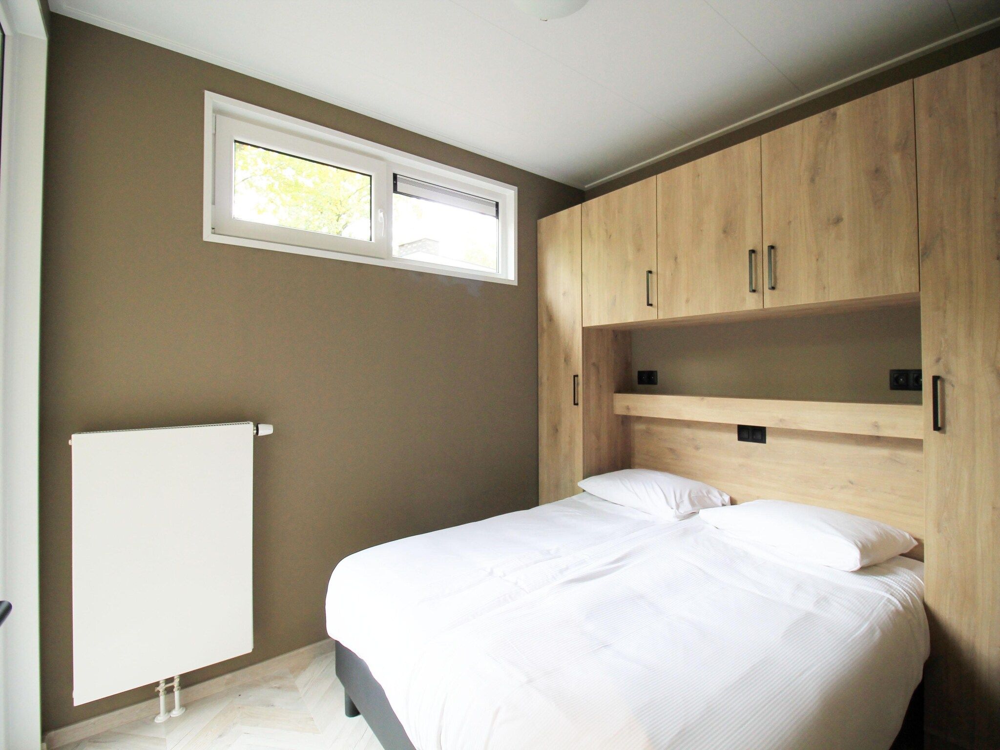 Een slaapkamer van Vakantiepark De Rimboe & De Woeste Hoogte 42 in Hoenderloo