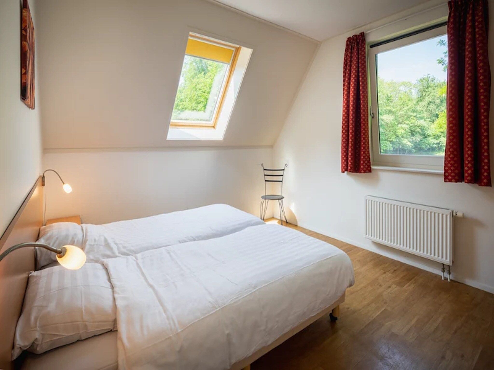 Een slaapkamer van Vakantiepark de Berkenhorst 15 in Kootwijk