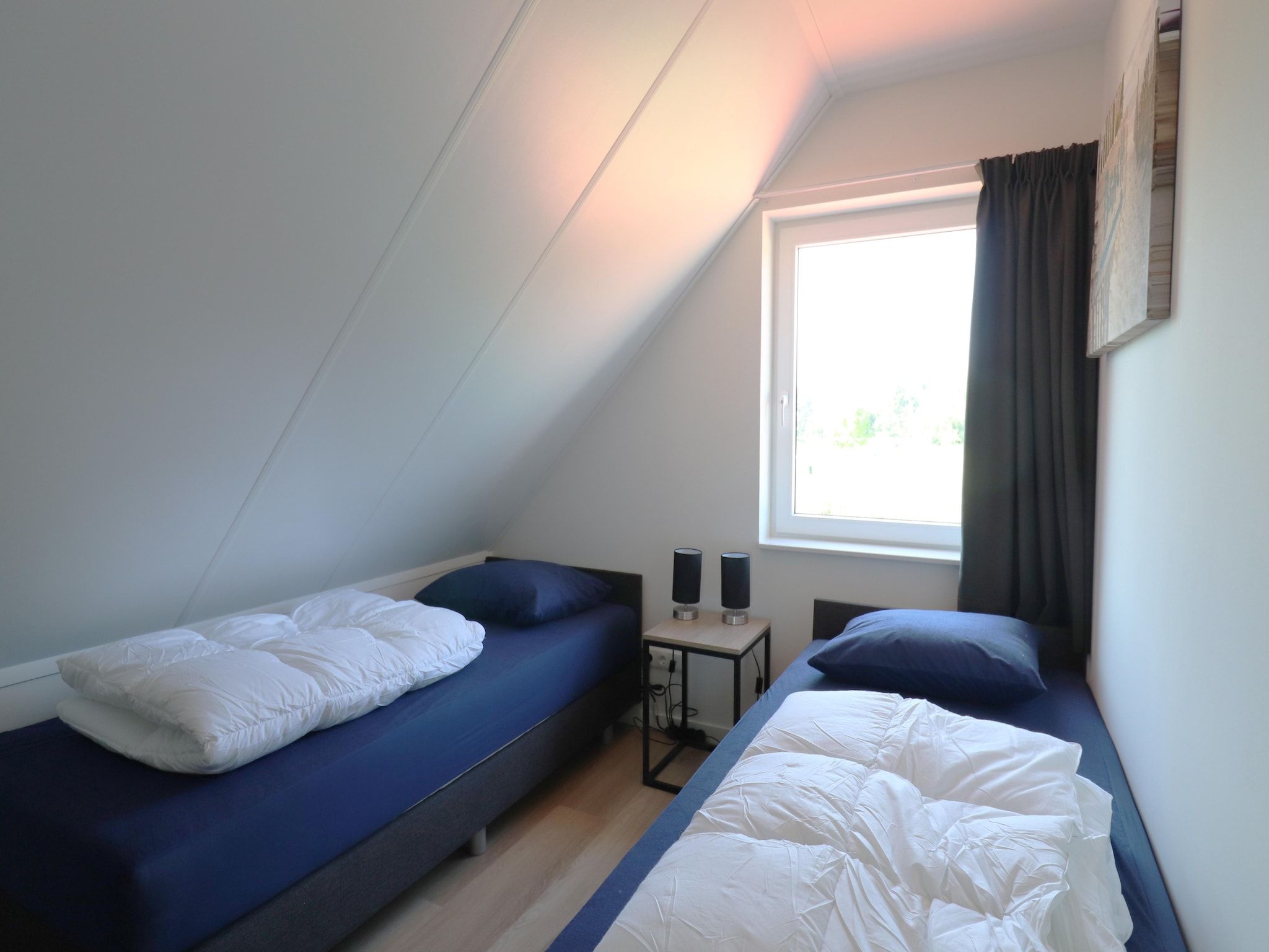 Een slaapkamer van Kuifduiker 122 in Simonshaven