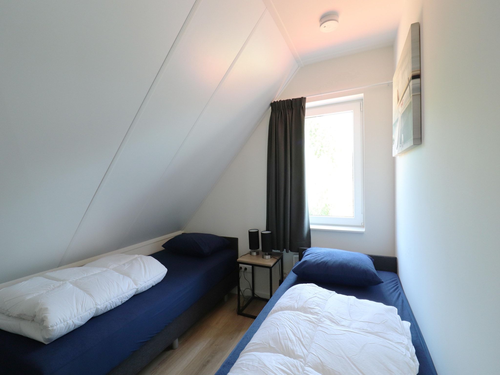 Een slaapkamer van Kuifduiker 122 in Simonshaven