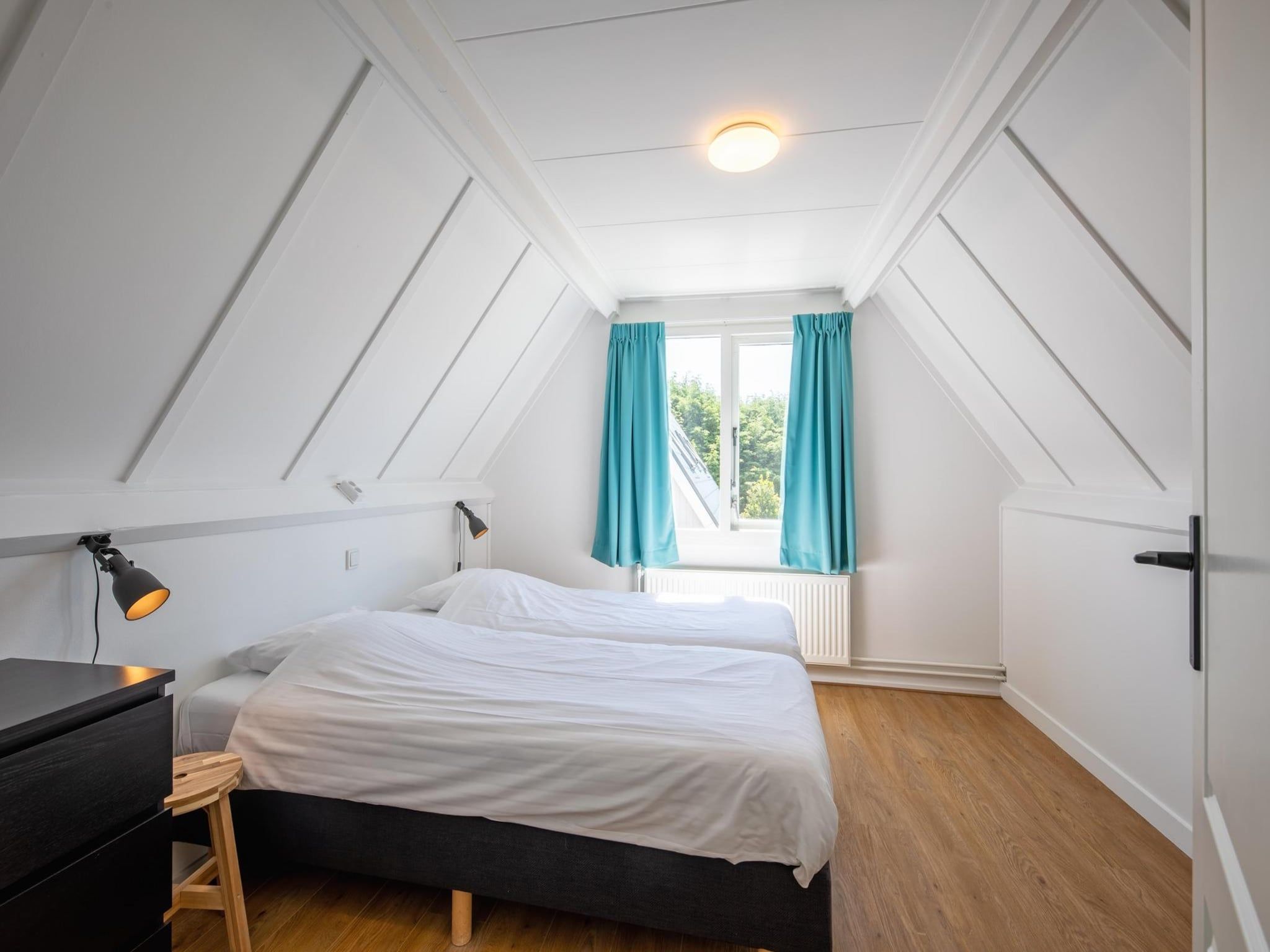 Een slaapkamer van Strandhuys Zeester in De Koog