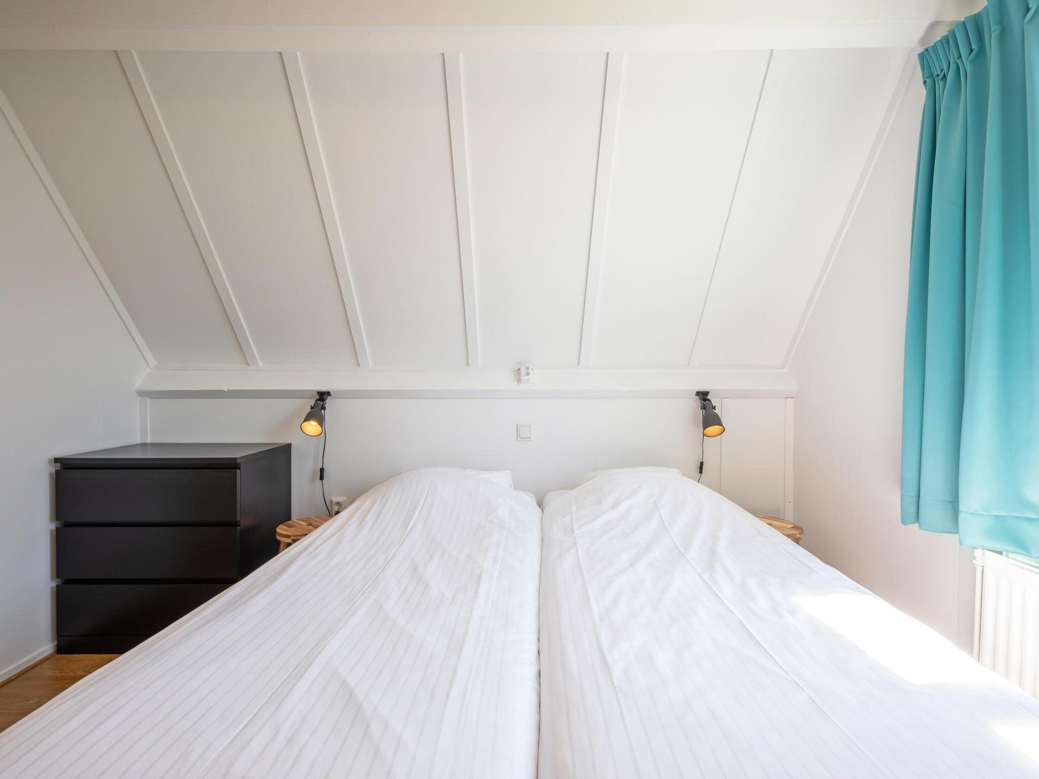Een slaapkamer van Strandhuys Zeester in De Koog