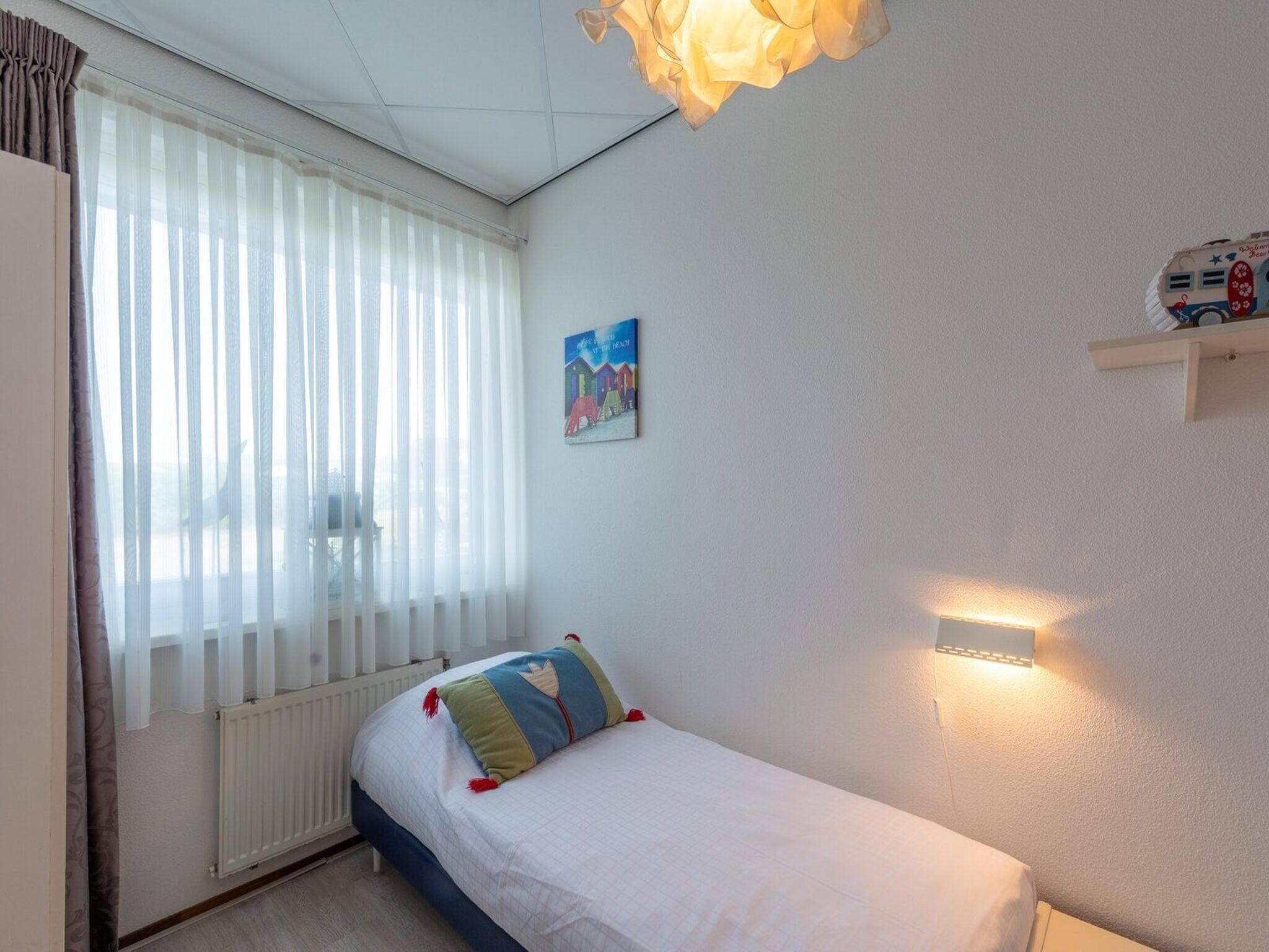 Een slaapkamer van Strandslag 107 in Julianadorp aan Zee