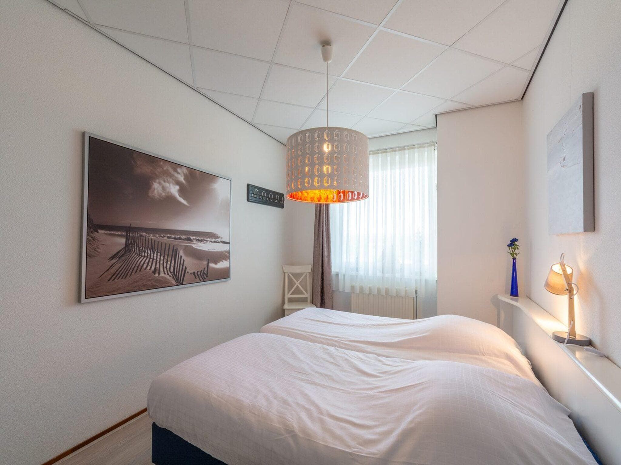 Een slaapkamer van Strandslag 107 in Julianadorp aan Zee