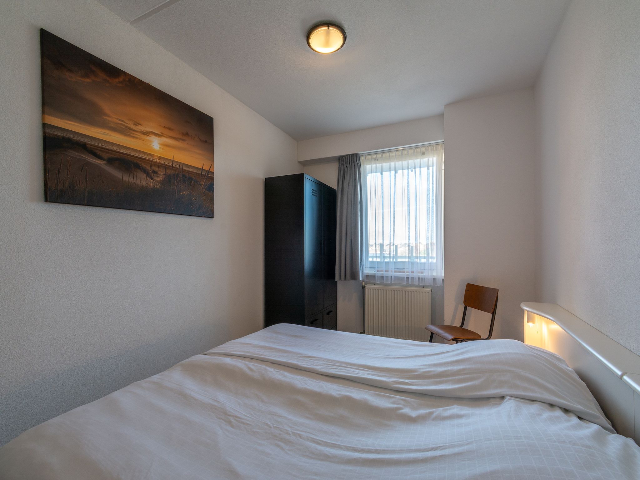Een slaapkamer van Strandslag 127 in Julianadorp aan Zee