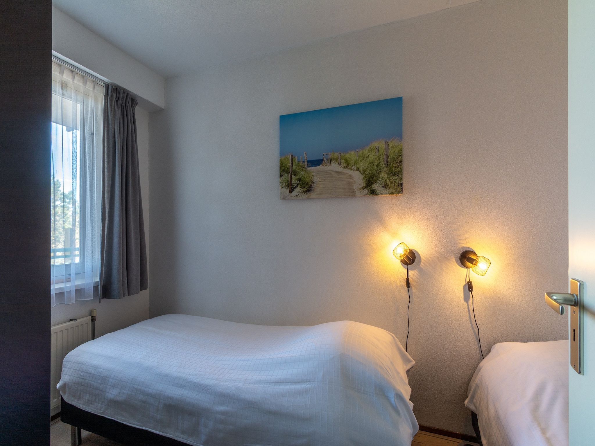 Een slaapkamer van Strandslag 127 in Julianadorp aan Zee