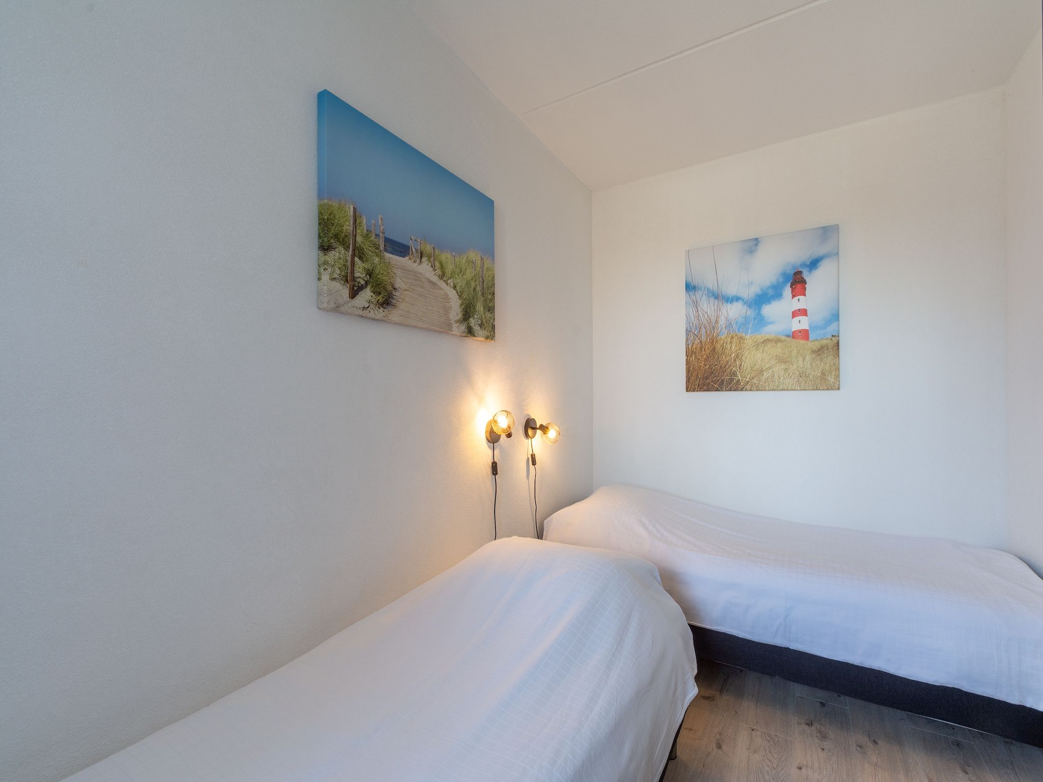 Een slaapkamer van Strandslag 127 in Julianadorp aan Zee