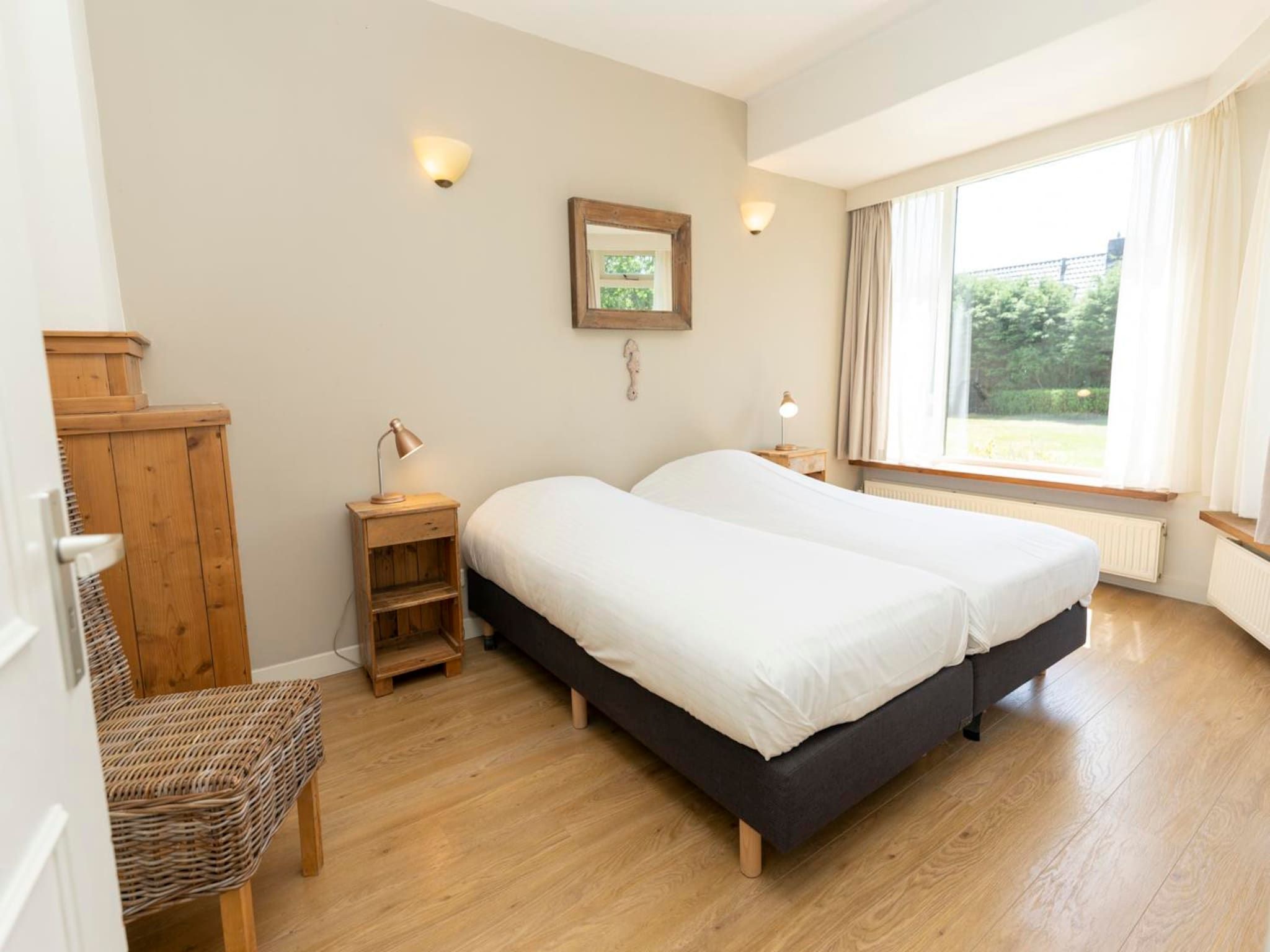 Een slaapkamer van Strandhuys Alikruik in De Koog