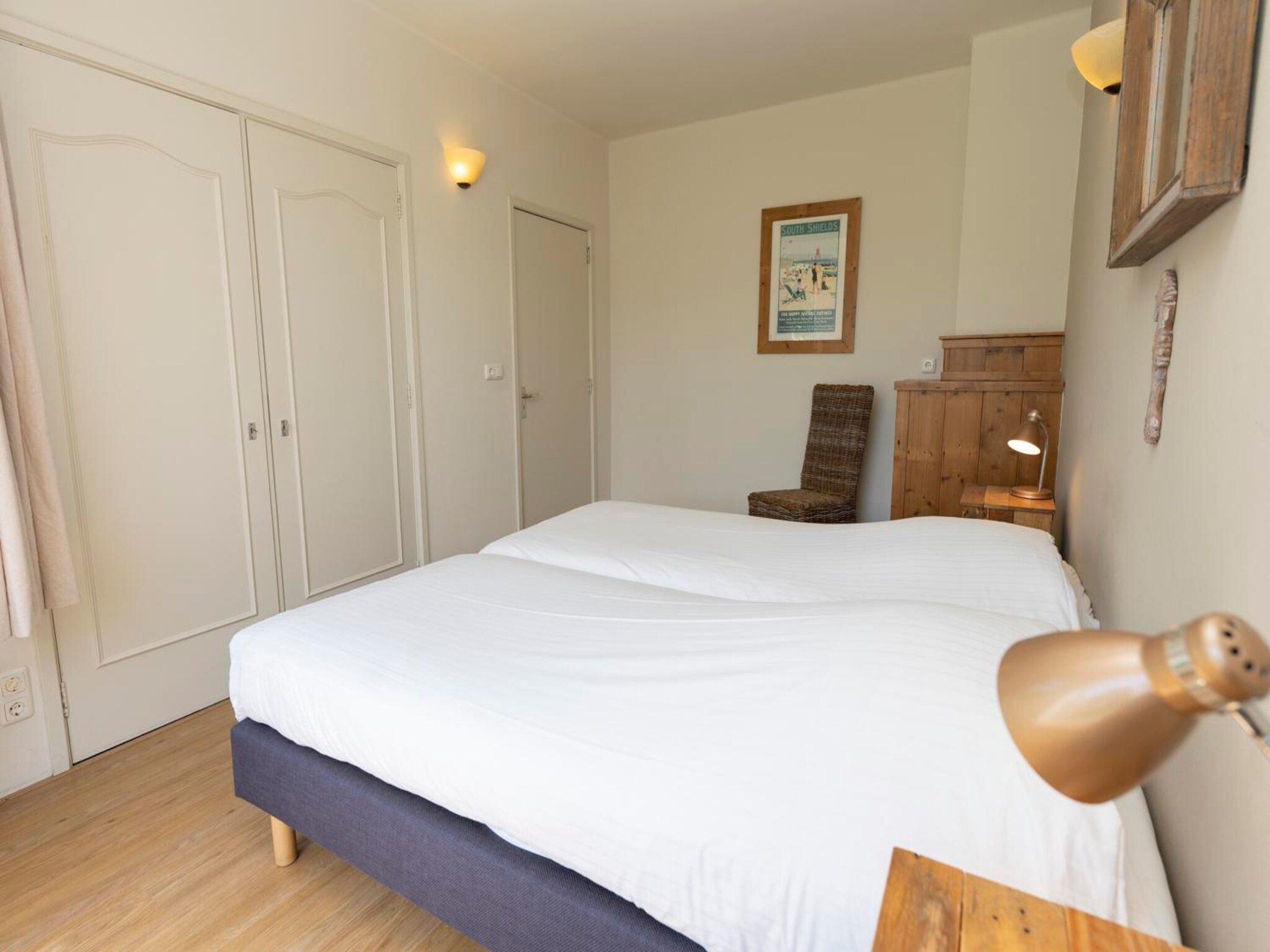 Een slaapkamer van Strandhuys Alikruik in De Koog