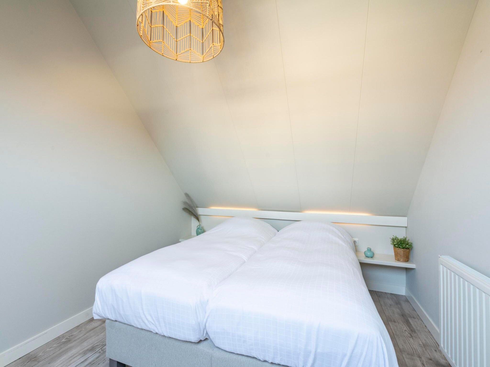 Een slaapkamer van Duinroosweg 83 in Callantsoog