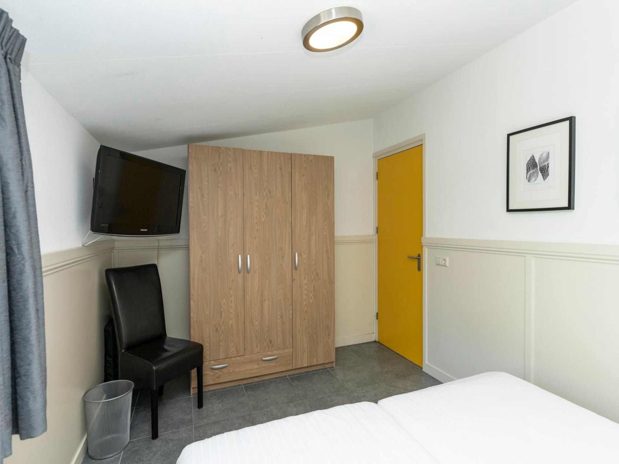 Een slaapkamer van Strandhuys Wulk in De Koog