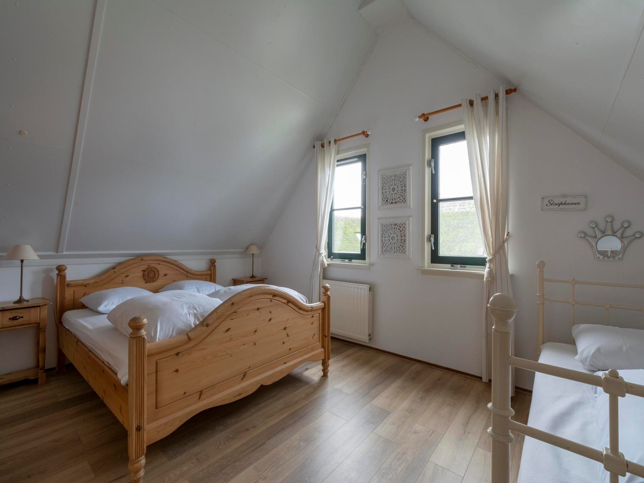Een slaapkamer van De Buitenplaats 138 in Callantsoog