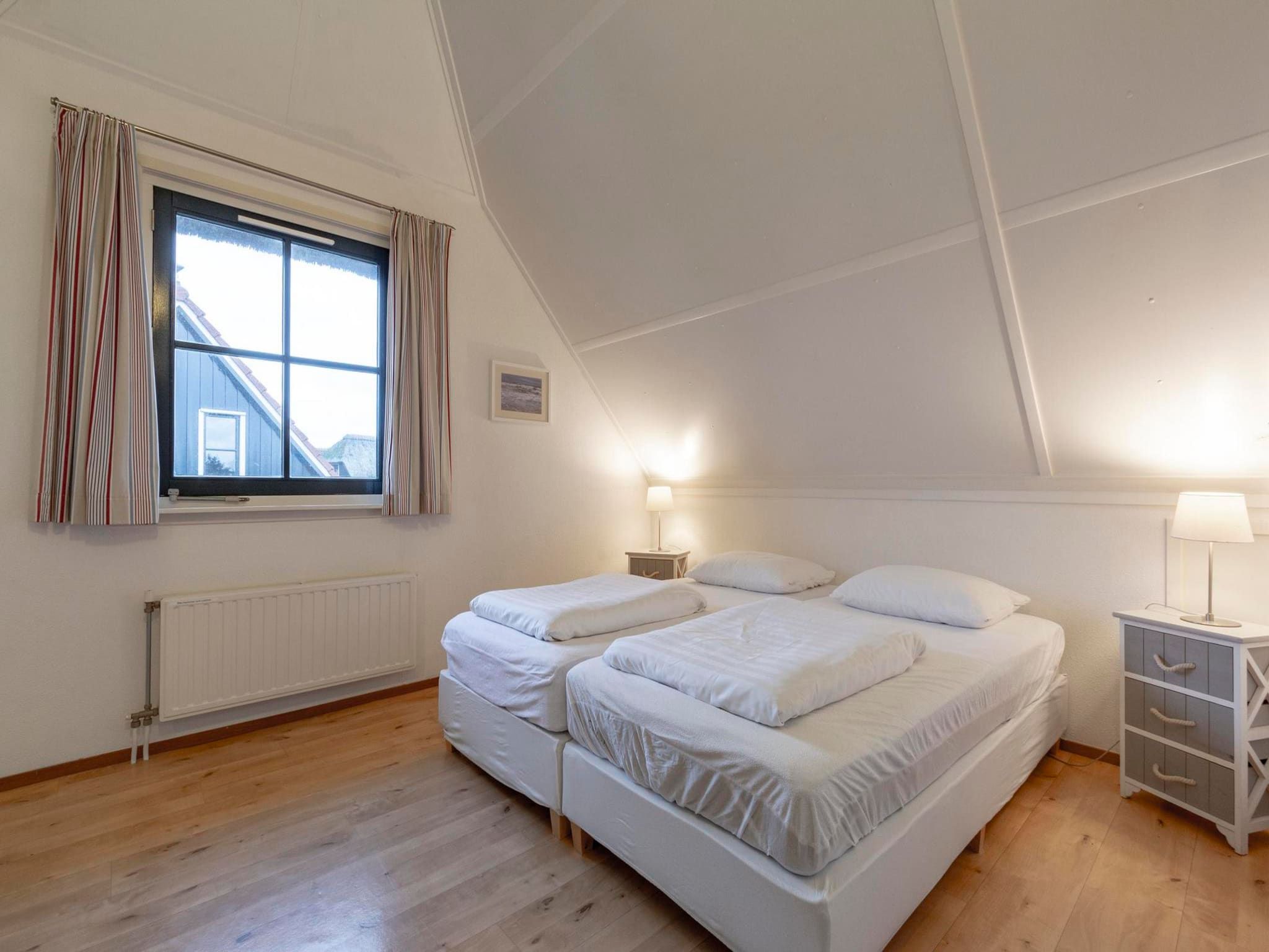 Een slaapkamer van De Buitenplaats 62 in Callantsoog