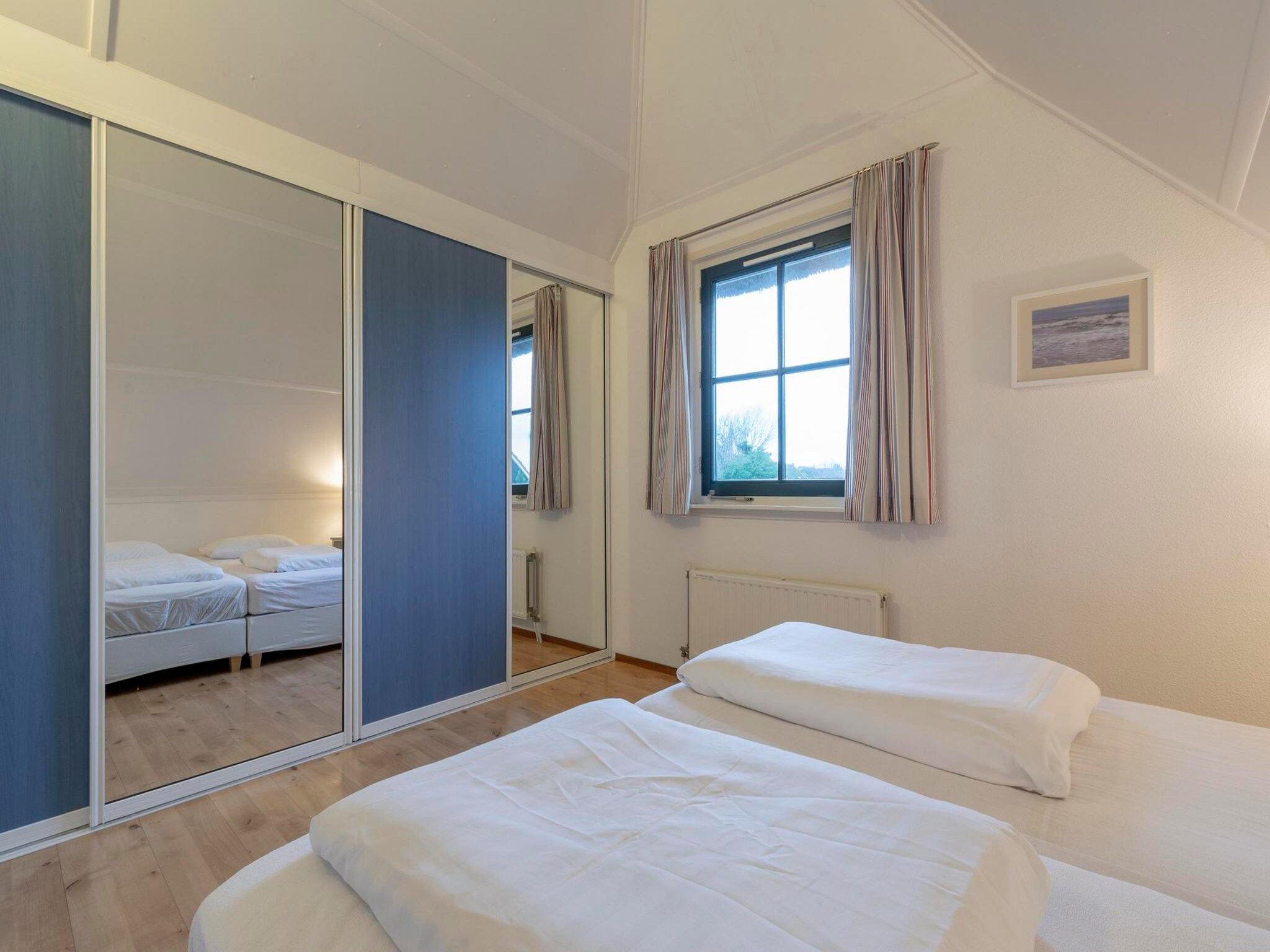 Een slaapkamer van De Buitenplaats 62 in Callantsoog