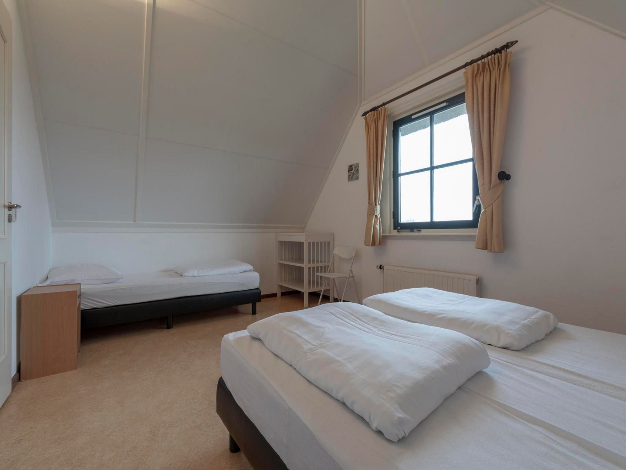Een slaapkamer van De Buitenplaats 97 in Callantsoog