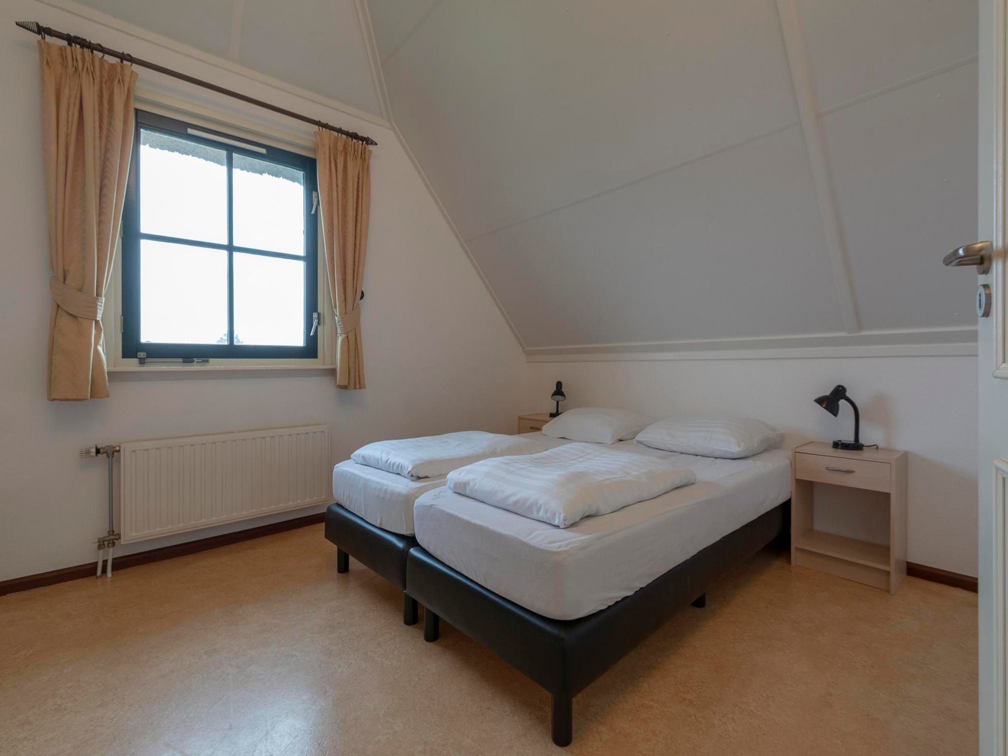 Een slaapkamer van De Buitenplaats 97 in Callantsoog