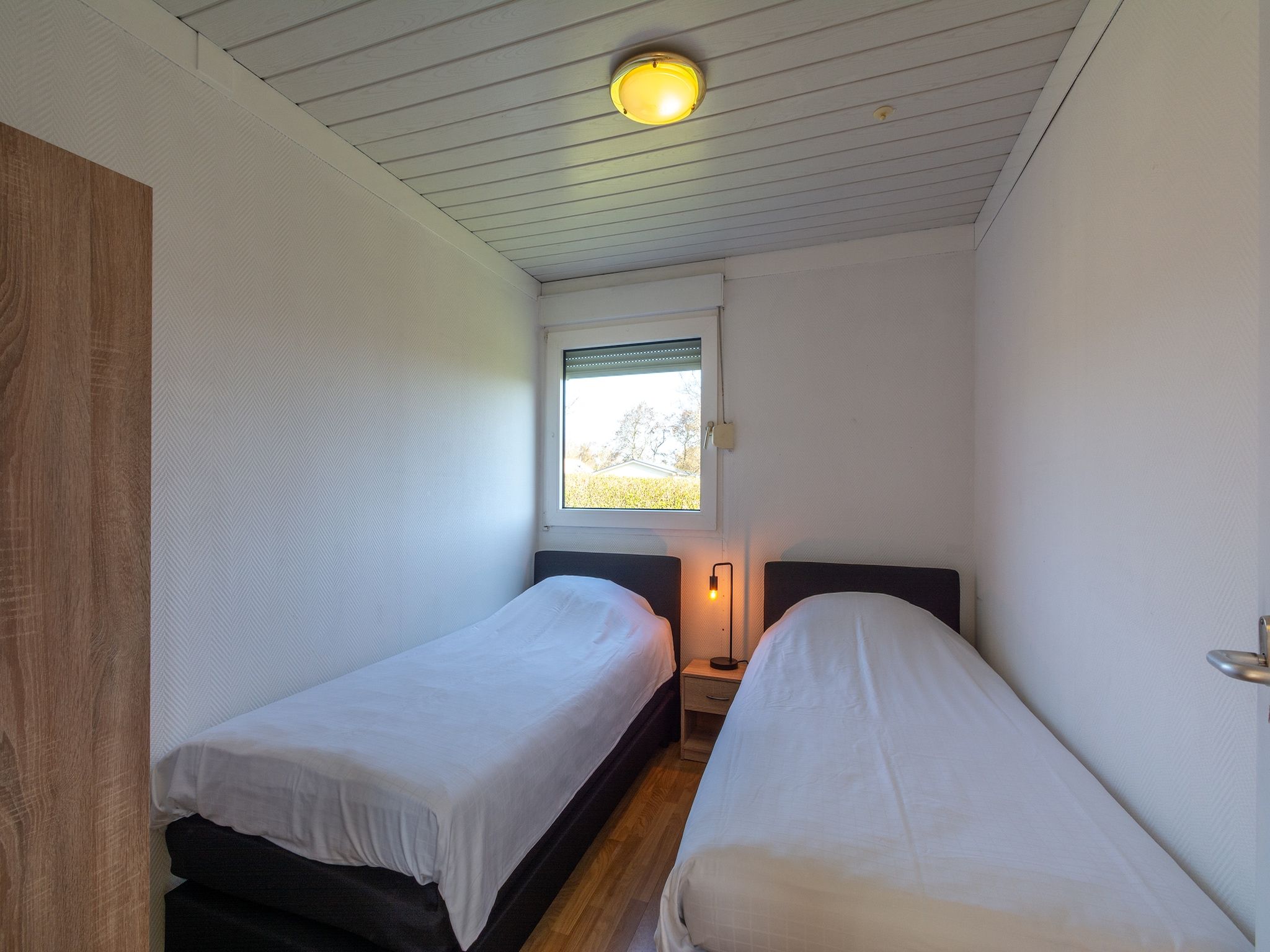 Een slaapkamer van Keizerskroon 58 in Julianadorp aan Zee