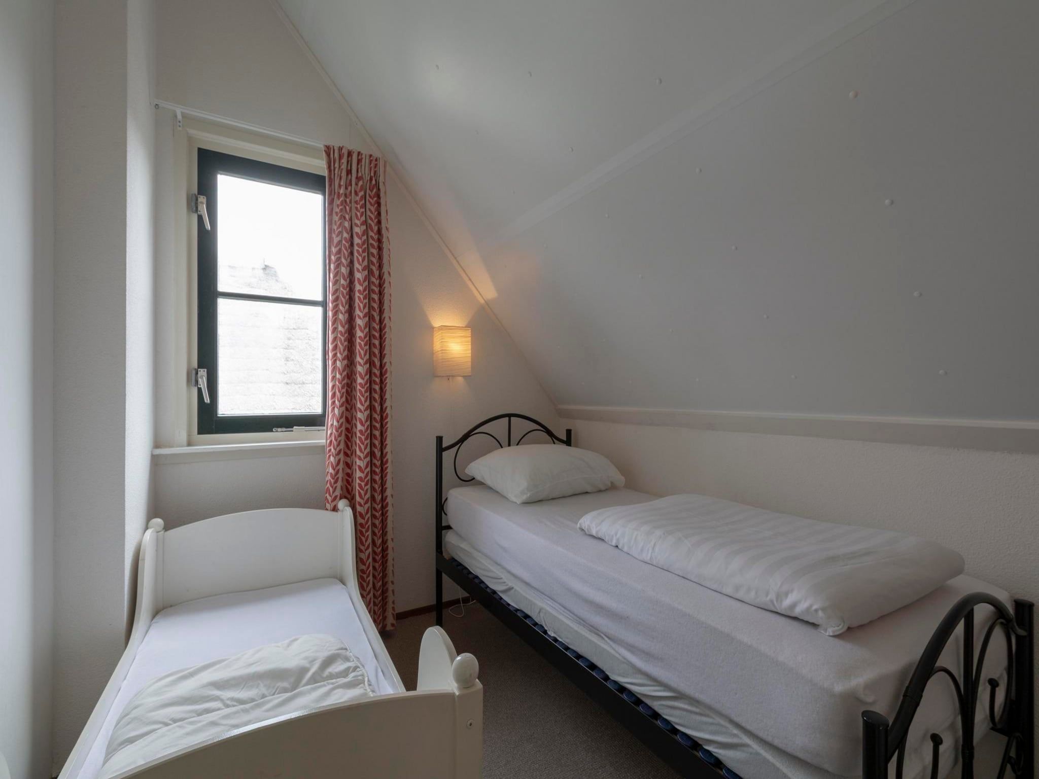 Een slaapkamer van De Buitenplaats 116 in Callantsoog