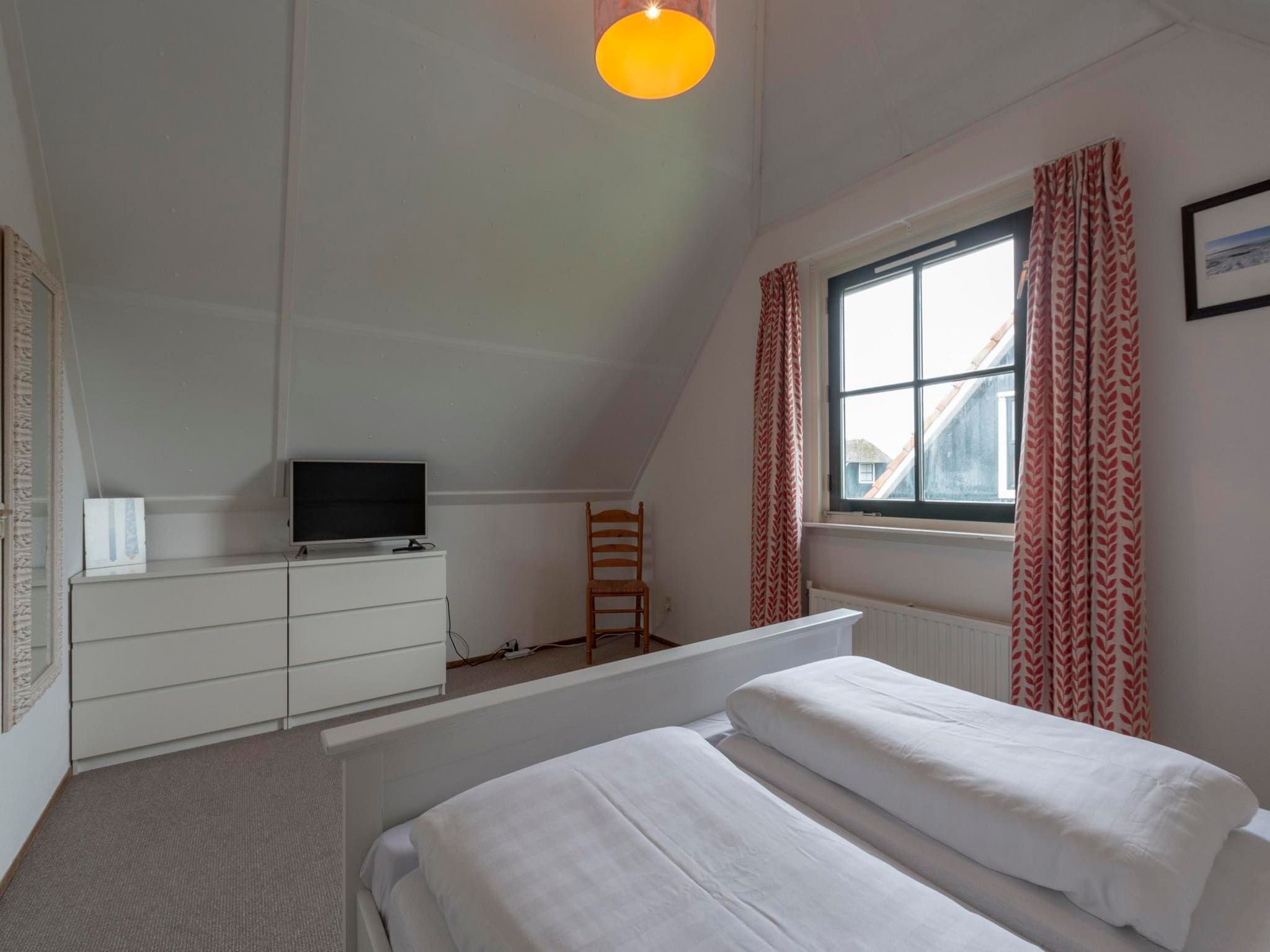 Een slaapkamer van De Buitenplaats 116 in Callantsoog