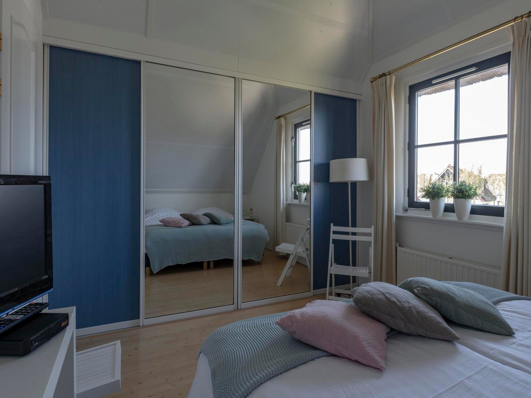 Een slaapkamer van De Buitenplaats 113 in Callantsoog