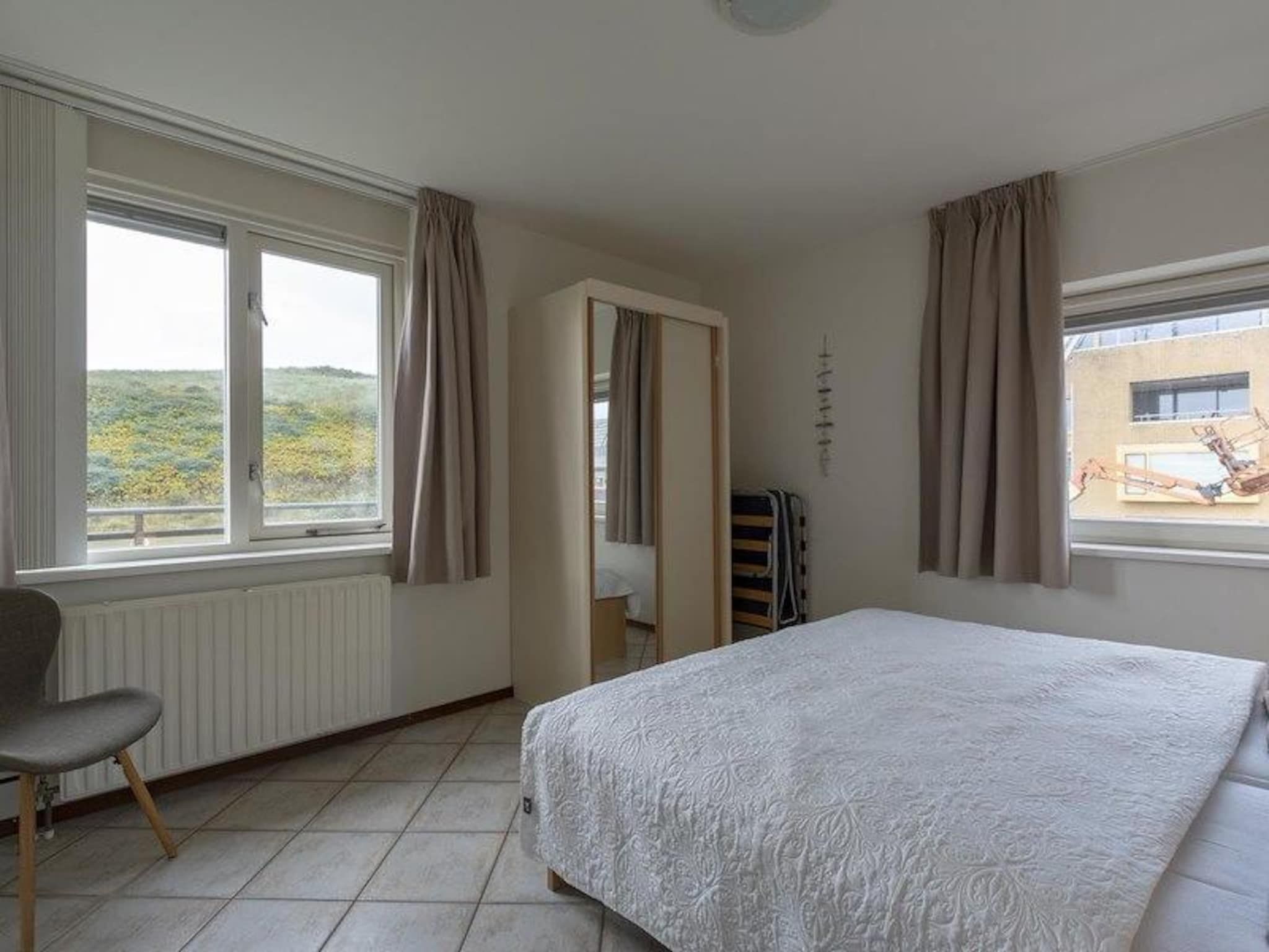 Een slaapkamer van Wijde Blick 212 in Callantsoog