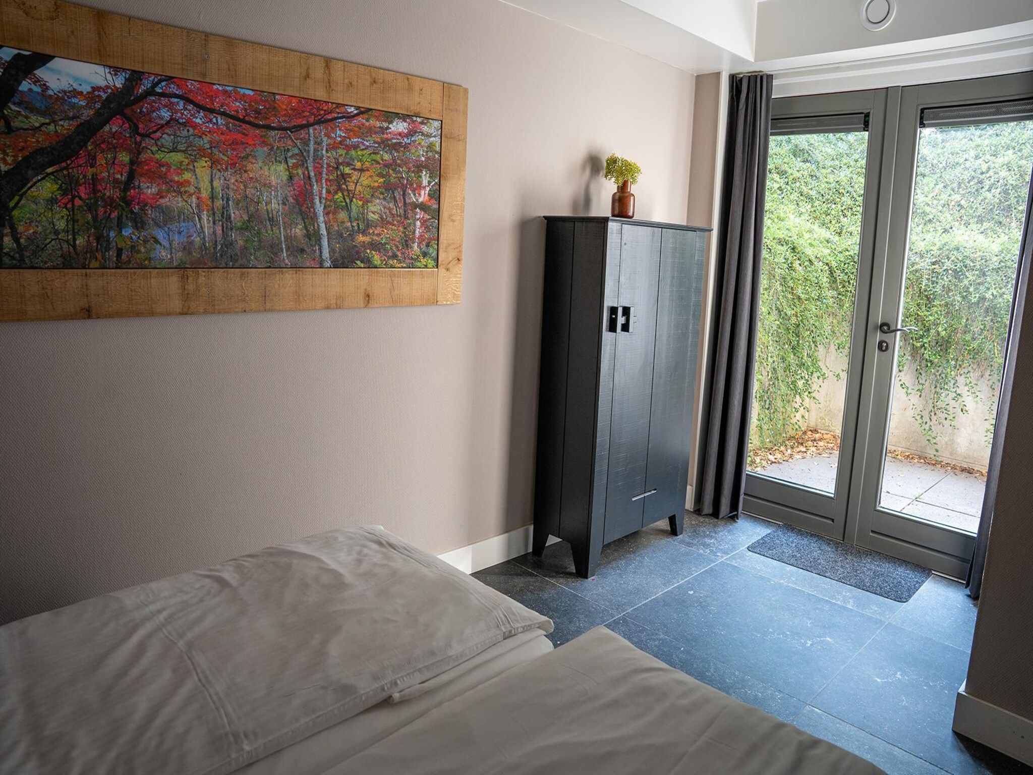 Een slaapkamer van Vlindervallei Boshuis 16p in Ermelo