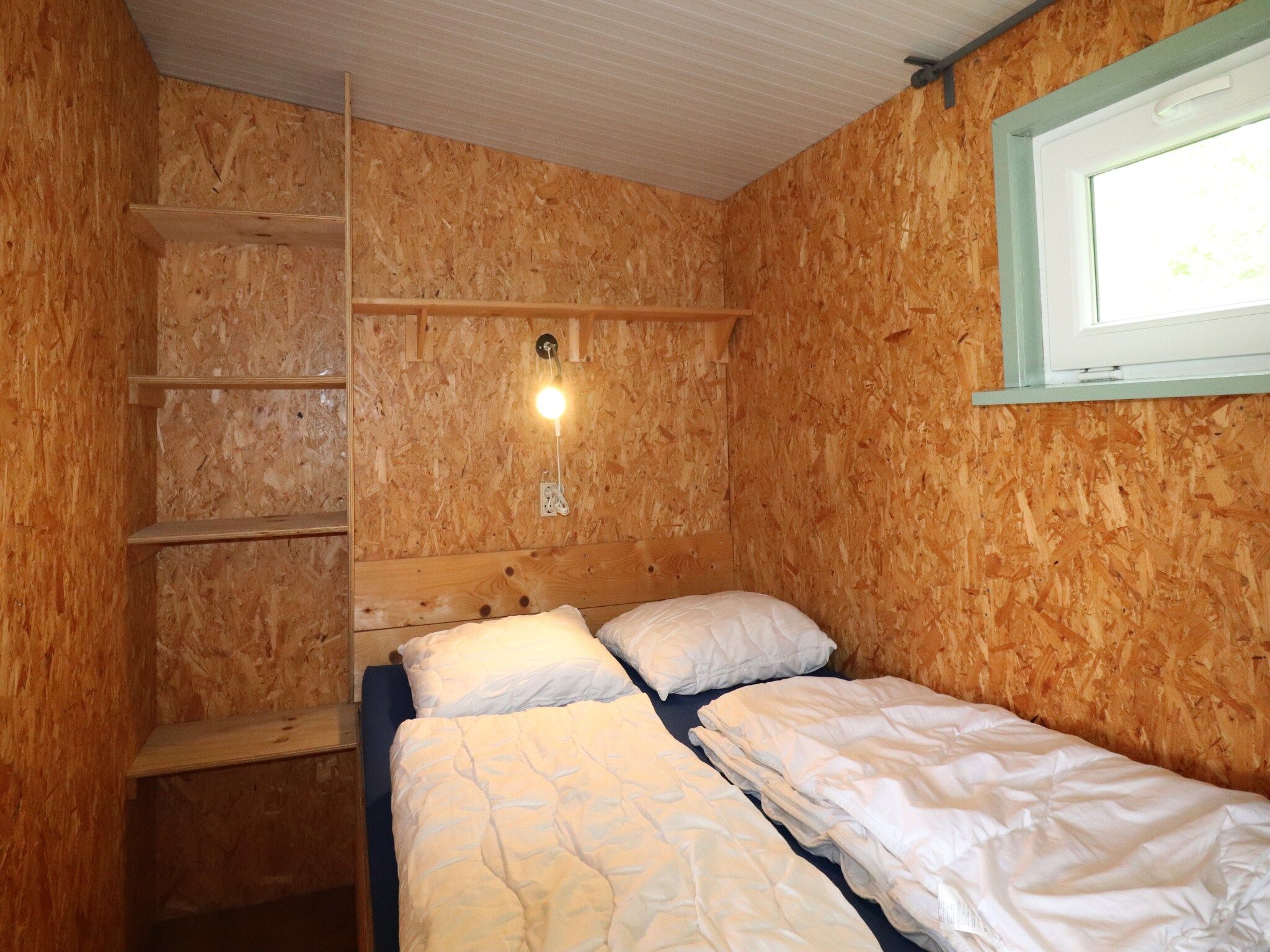 Een slaapkamer van Cosy cabin 1 in Heeg