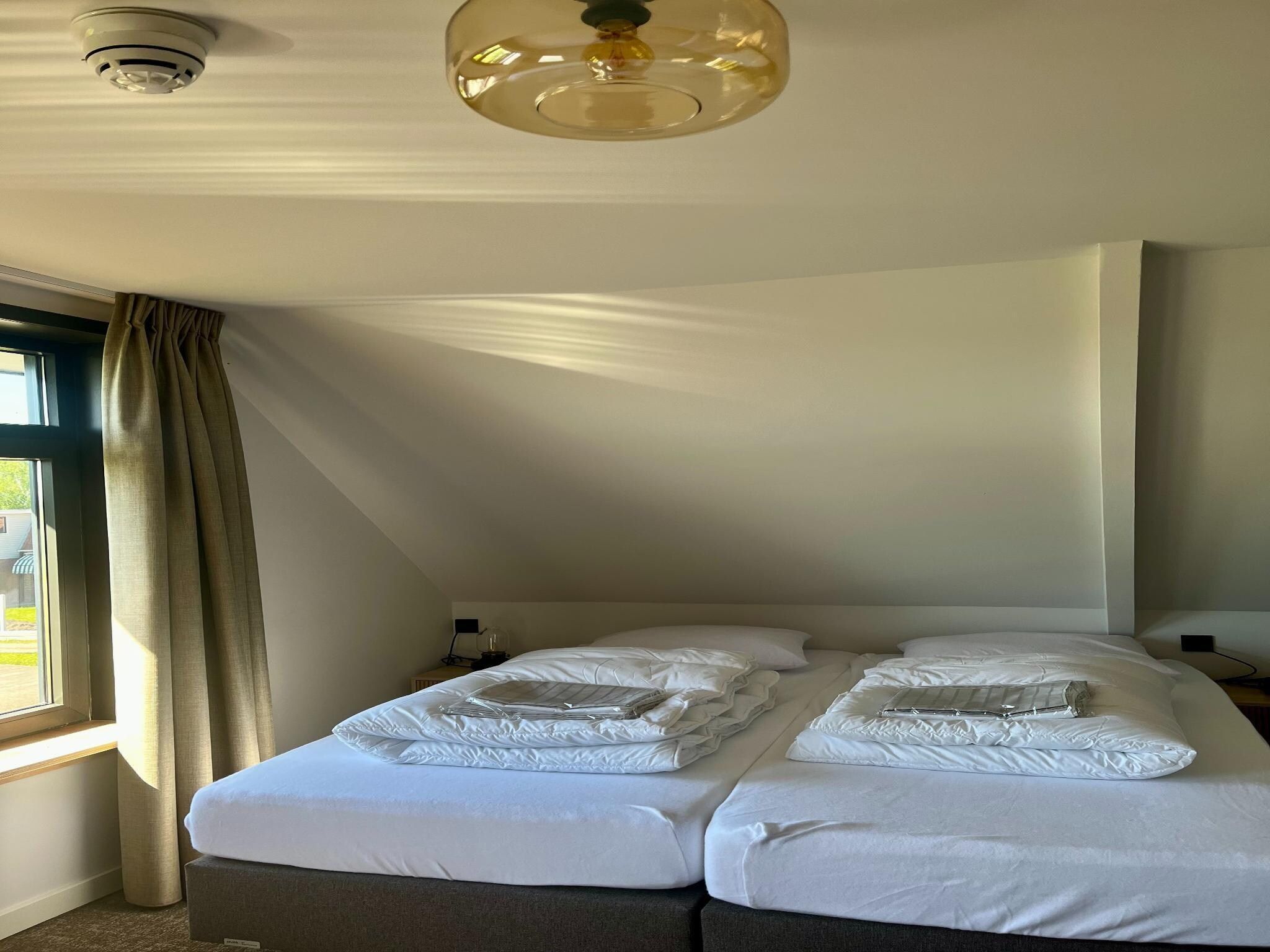Een slaapkamer van Groepsaccommodatie voor 20 personen + 5 Tiny Greenhouses voor 2 tot 4 personen in Scherpenzeel (FR)