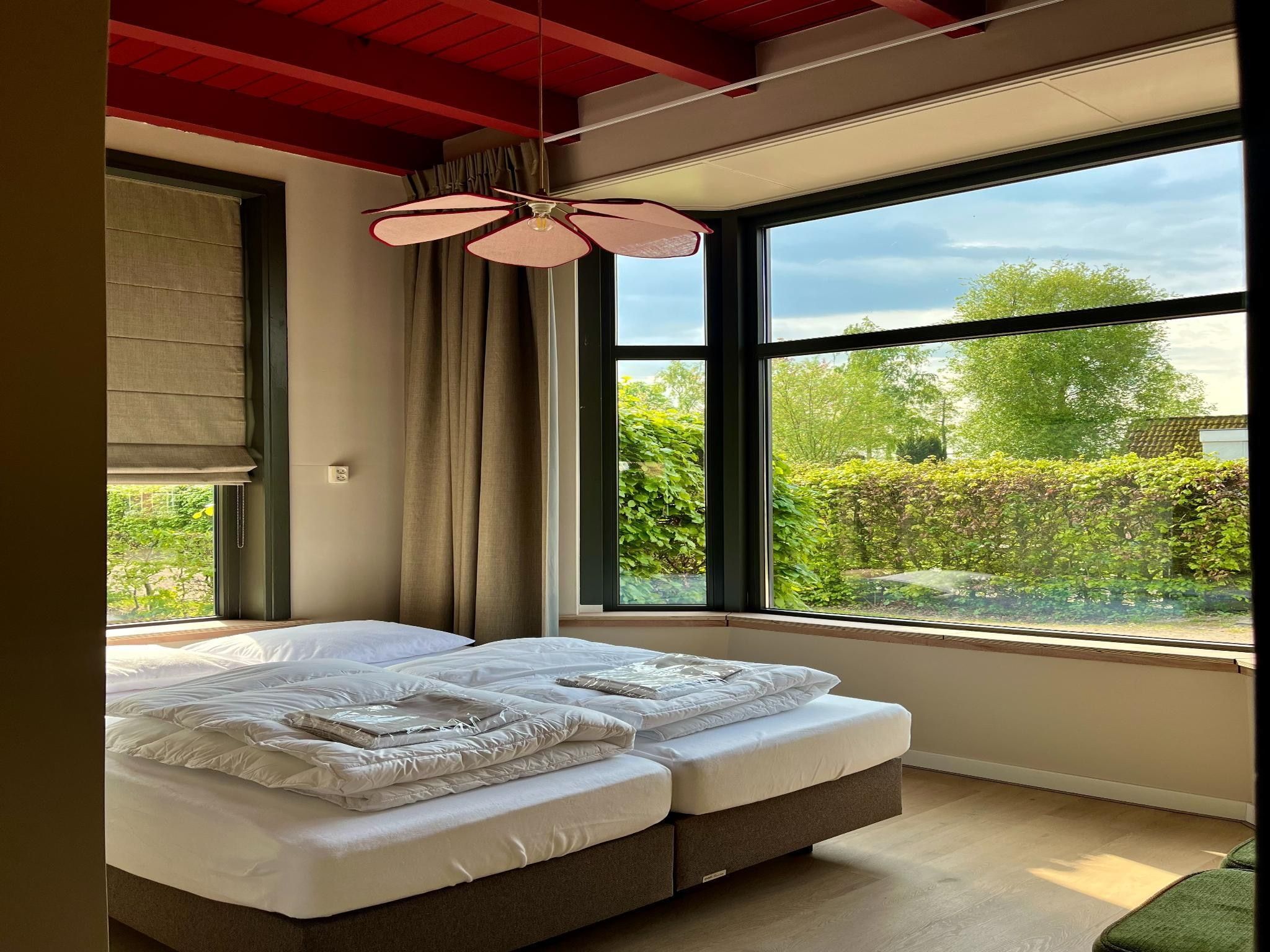 Een slaapkamer van Groepsaccommodatie met 10 luxe tweepersoons kamers in Scherpenzeel