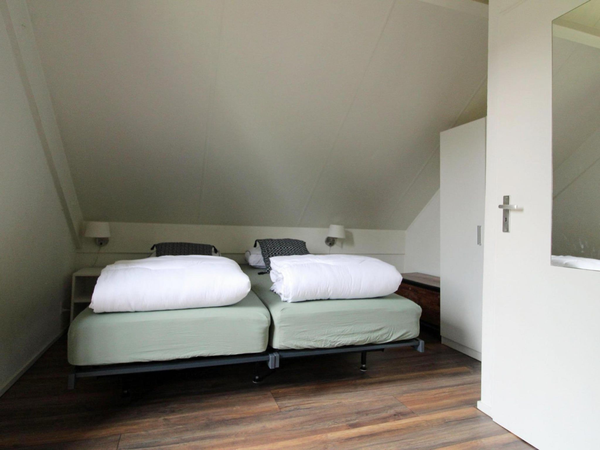 Een slaapkamer van 6 - Persons Bungalow La Moufflon in Ewijk