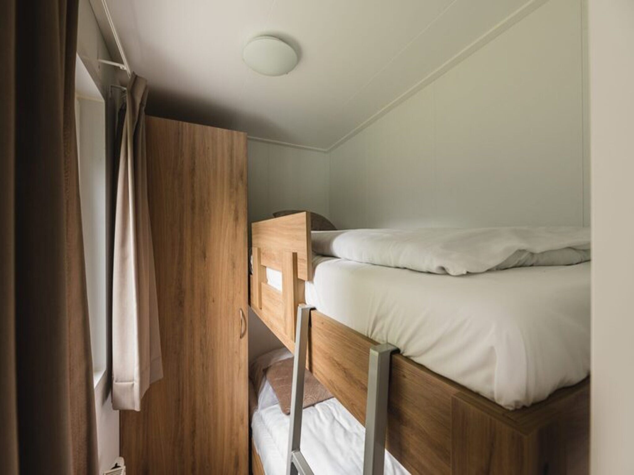 Een slaapkamer van Luxury lodge with private sauna | 6 people in Rijssen