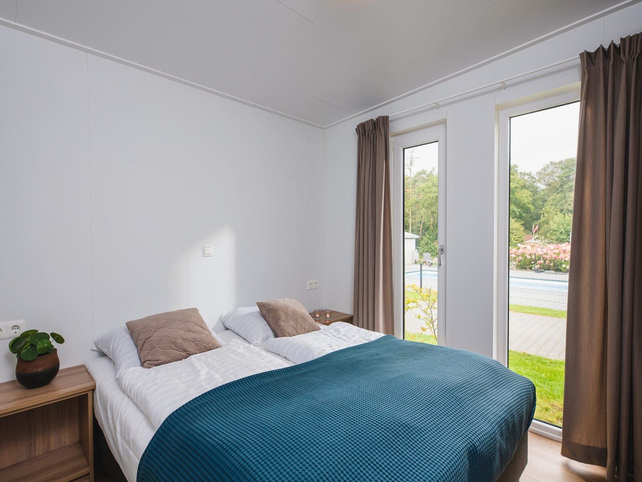 Een slaapkamer van Luxury lodge with private sauna | 6 people in Rijssen