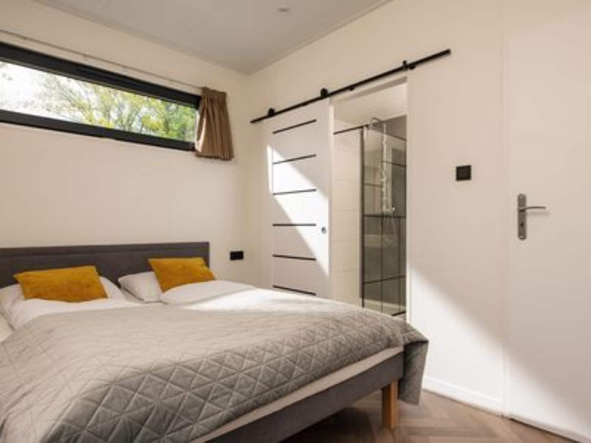 Een slaapkamer van Oak Lodge I 4 people in Rijssen