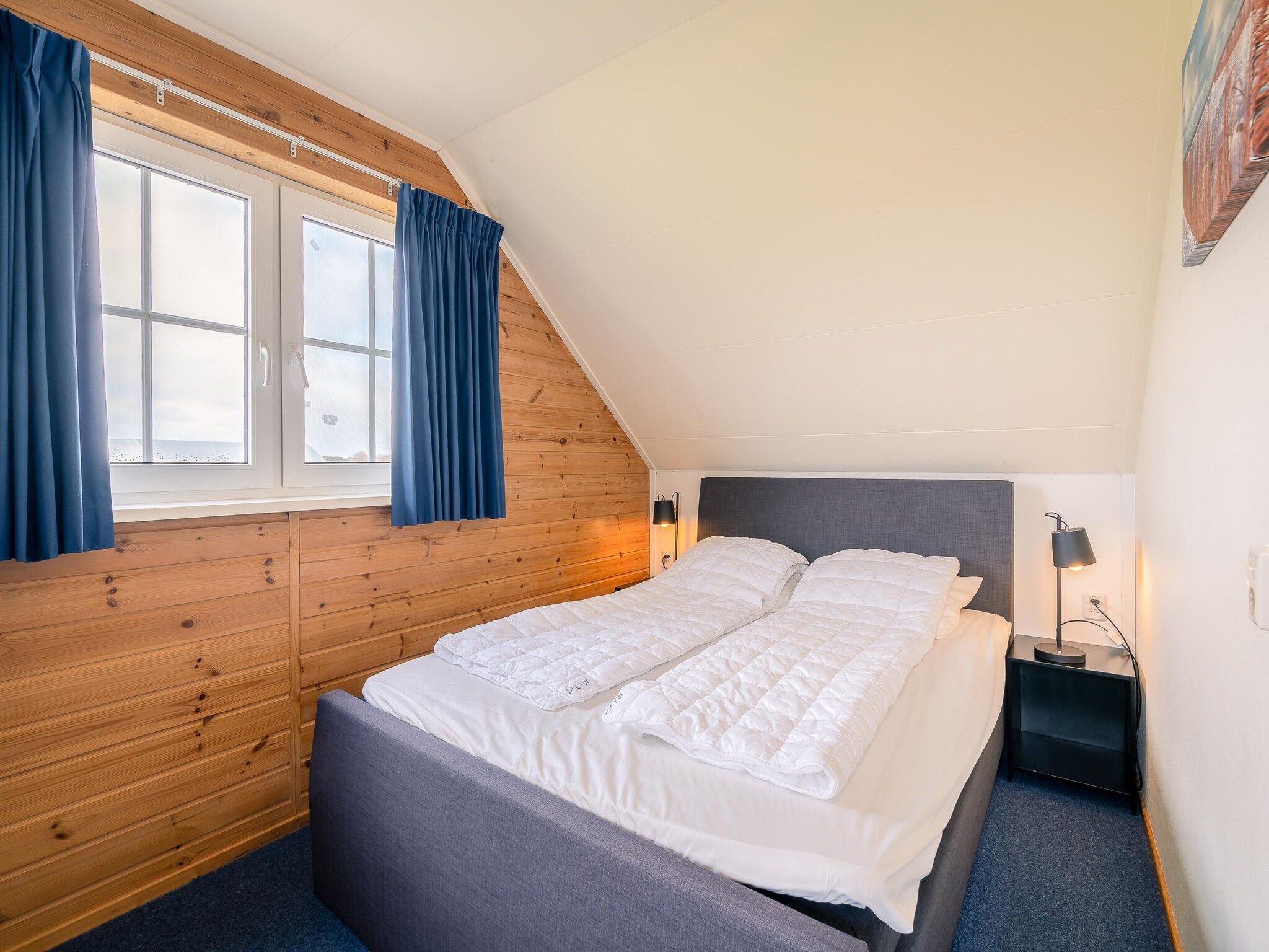 Een slaapkamer van De Annabella 13- De Tjiftjaf in De Koog