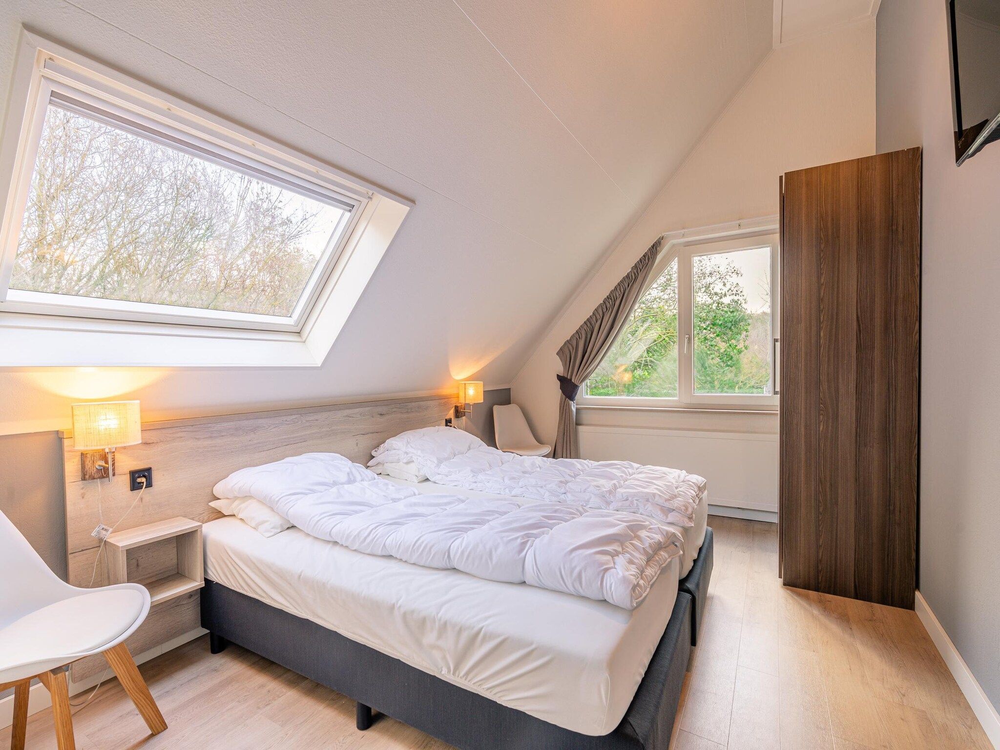 Een slaapkamer van Kamperfoelie 73 in De Koog