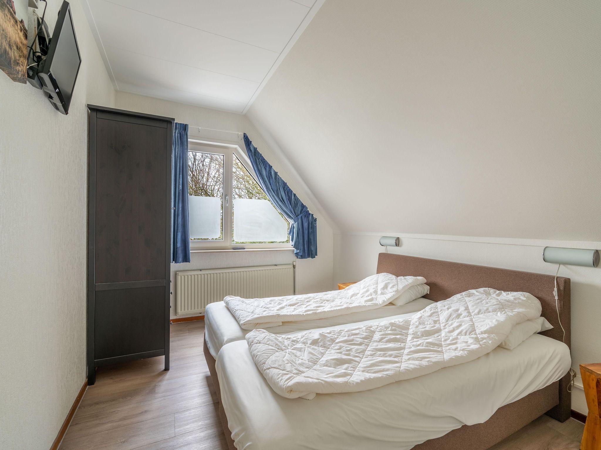 Een slaapkamer van Kamperfoelie 43 in De Koog