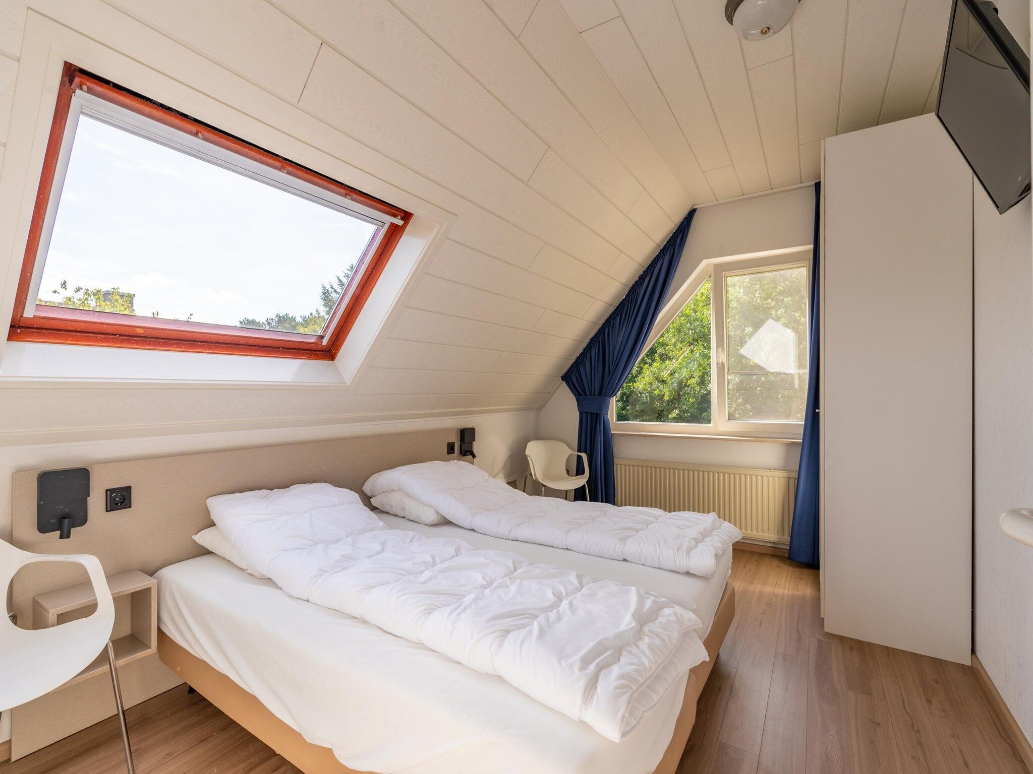 Een slaapkamer van Kamperfoelie 89 in De Koog