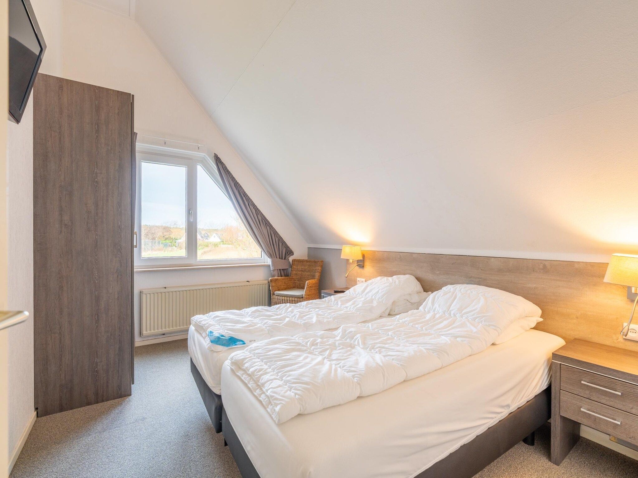 Een slaapkamer van Kamperfoelie 59 in De Koog