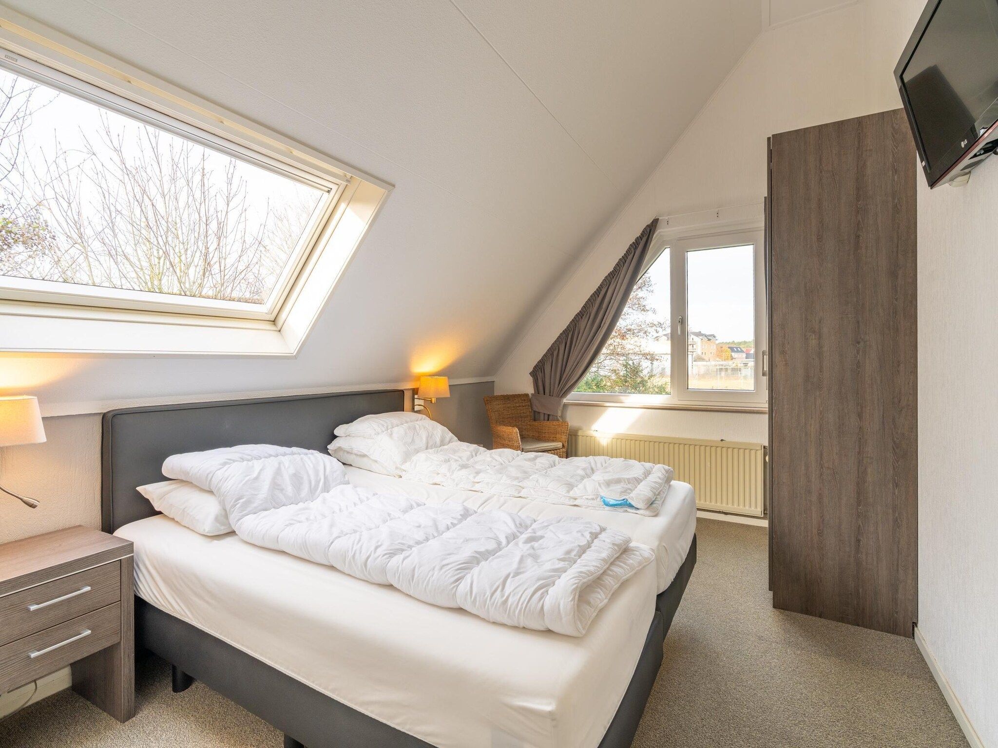 Een slaapkamer van Kamperfoelie 59 in De Koog